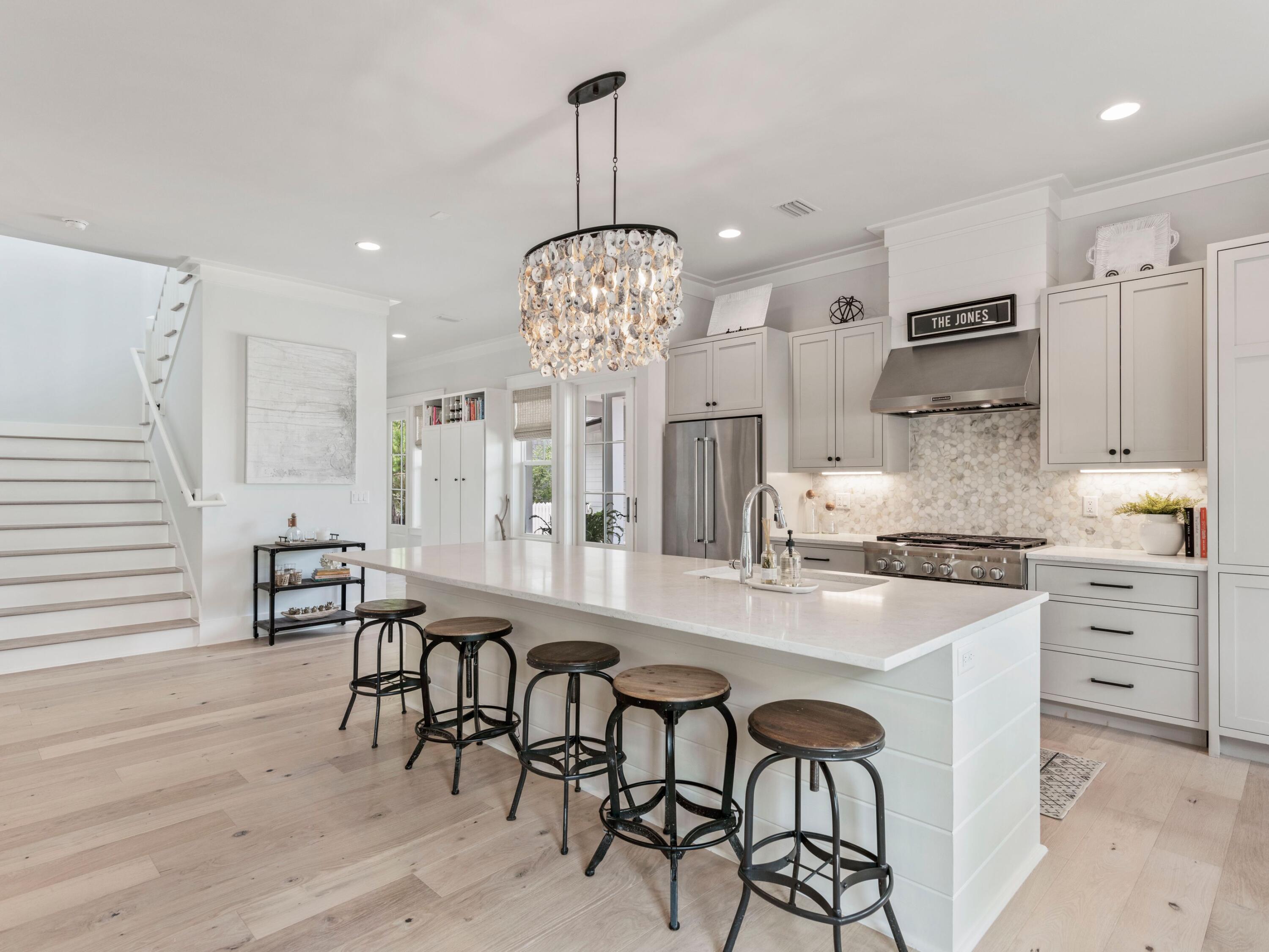 Experience the pinnacle of pure luxury with this beautifully crafted Jason Romair home in one of the best locations within Watersound Origins. This bespoke designer home has been meticulously curated with the finest finishes including brand new white-oak hardwood floors and freshly painted throughout. The Cape-Cod design features its own private oasis including an oversized back yard with a sprawling porch and outdoor Wolf kitchen that backs up to forever green space, creating the ultimate sense of privacy. Situated on the south side of Splash Drive, the ample spacing provided by this section of Watersound Origins is truly unique.
