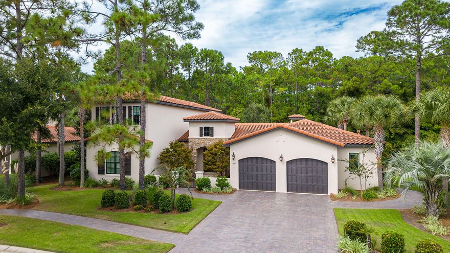 Pristine custom built home with an abundance of unique architectural details throughout! Solid Walnut hadwood flooring, Built-in shelving, Crown molding,lit stairway,and a Hidden Mirror TV. Perfect for entertaining, the oversized living area flows into the 22-foot dining  complete with built-in buffet. Chefs kitchen featuring Wolf and Sub Zero Appliances,warming drawer, center island wirh prep-sink, large pantry and Farmhouse sink with a picturesque view. Step outside to a Saltwater pool, spa, & living space with fireplace, TV, and summer kitchen all inside a protective Lanai. Privacy and beauty surround the home with professional landscaping and lighting.Primary Suite & Guest Suite located on the main level, two additional  Guest Suites on the second level all with dedicated ensuite bath