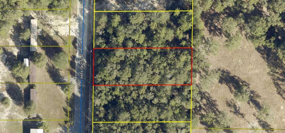 GREAT BUILDABLE LOT! Wooded lot with an 8' privacy fence across the back of the lot. Build your new home or bring your mobile home. Tap fee has been paid and land has been surveyed. Call for a showing today!