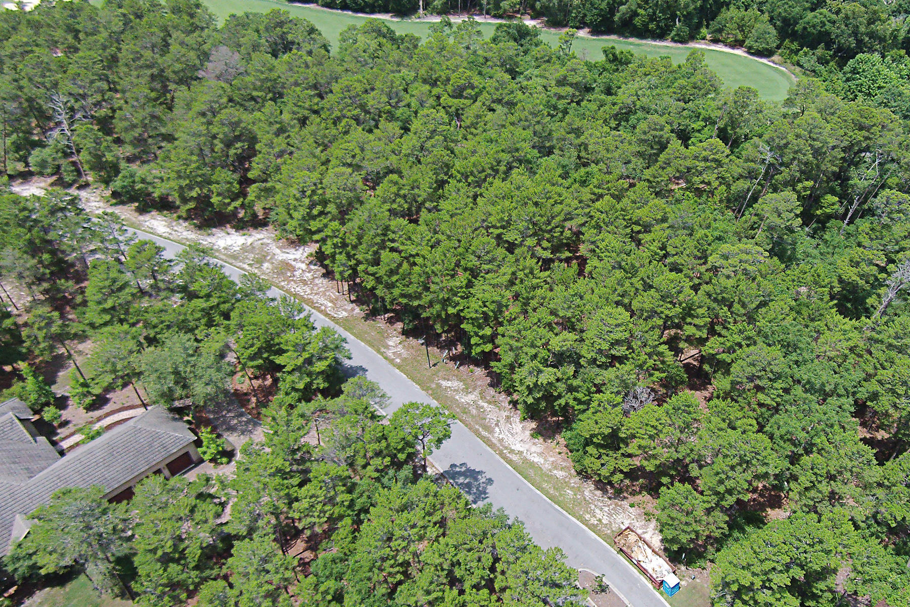 Nearly one full acre, this wooded Wild Heron lot backs up to the 12th tee of the Greg Norman-designed Shark's Tooth Golf Course. Its size will allow most if not all living space in your future home to be contained conveniently at ground level. Set near the end of Shark's Tooth Trail, which culminates in a cul-de-sac, you can expect exceptional tranquility with only seven properties located past it. The 734-acre refuge of Wild Heron is convenient to the attractions of Panama City Beach that include emerald waters, a wide variety of shops and restaurants, as well as seasonal events.