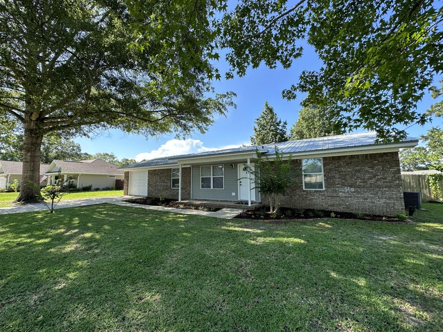 Don't miss this charming homesite! Notice the beautiful landscaping in the front and back yard, with plenty of shade trees for those summer days. The backyard is privacy fenced with sidewalks/ a grilling area and gives plenty of space for your boat or RV and a 12x12 tool shed.This 4 bedroom 2 bathroom home with a converted garage, gives endless options to meet your needs.The double-pane windows throughout the home create a light and bright atmosphere. Lots of upgrades! All brick, metal roof, front and rear porches ,level, fenced !  If you're heading to the beach or making a grocery run, this property gives easy access to both Hwy 85 and Hwy 90.