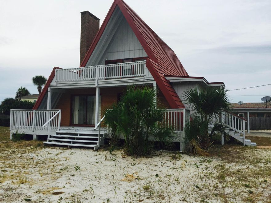 ISLAND LIVING AT ITS BEST- GULF VIEW PROPERTY! YOU MUST SEE THIS WONDERFULLY UNIQUE HOME ON A LARGE CORNER LOT. HUGE LIVING AREA W/ WOOD BURNING BRICK FIREPLACE, BEAMED VAULTED CEILING & 2 SETS OF SLIDING GLASS DOORS TAKE YOU OUT ONTO YOUR 35 FT. COVERED DECK. NICE KITCHEN W/ ALL APPLIANCES IN PLACE. LG INSIDE UTILITY RM W/ PANTRY- W/D STAY! 2 (GOOD SIZE) BEDRMS & 1 BATH DOWNSTAIRS. UPSTAIRS IS THE MASTER SUITE. FEEL THE BREEZES & VIEW THE OCEAN FROM YOUR 20 X 12.5 FT 2ND STORY DECK. DON'T MISS THE HUGE STORAGE AREA THRU THE MASTER CLOSET. NEWER FLOORING EXCEPT FOR THE MASTER BATHROOM & UTILITY ROOM! NEEDS SOME UPDATING...JUST ADD YOUR PERSONAL TOUCHES! PLEASE HAVE OFFER ACCOMPANIED BY LOAN APPROVAL LETTER OR POF.