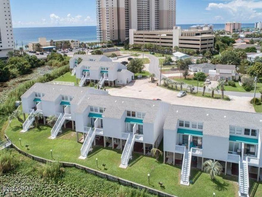 Wow! Like BRAND NEW ground-level condo fully updated with modern finishes just 1/2 block from beach on the popular west end of Panama City Beach! Enjoy beautiful lake views from your private patio! You really can have it all here and not break the bank! This studio is perfect for a second home, vacation rental, or for affordable long term efficiency living! Lullwater Lake Beach Condominiums complex is low density so No elevators! Owners have ample parking and love their pool, bbq grills, new private dock. This unit comes with a bright white farmhouse chic kitchen, granite counters, tile floors, updated bathroom vanity dishwasher, refrigerator, stove, lovely dining area, open concept living, and comes completely finished! Make this unit yours and start your Florida dream today!