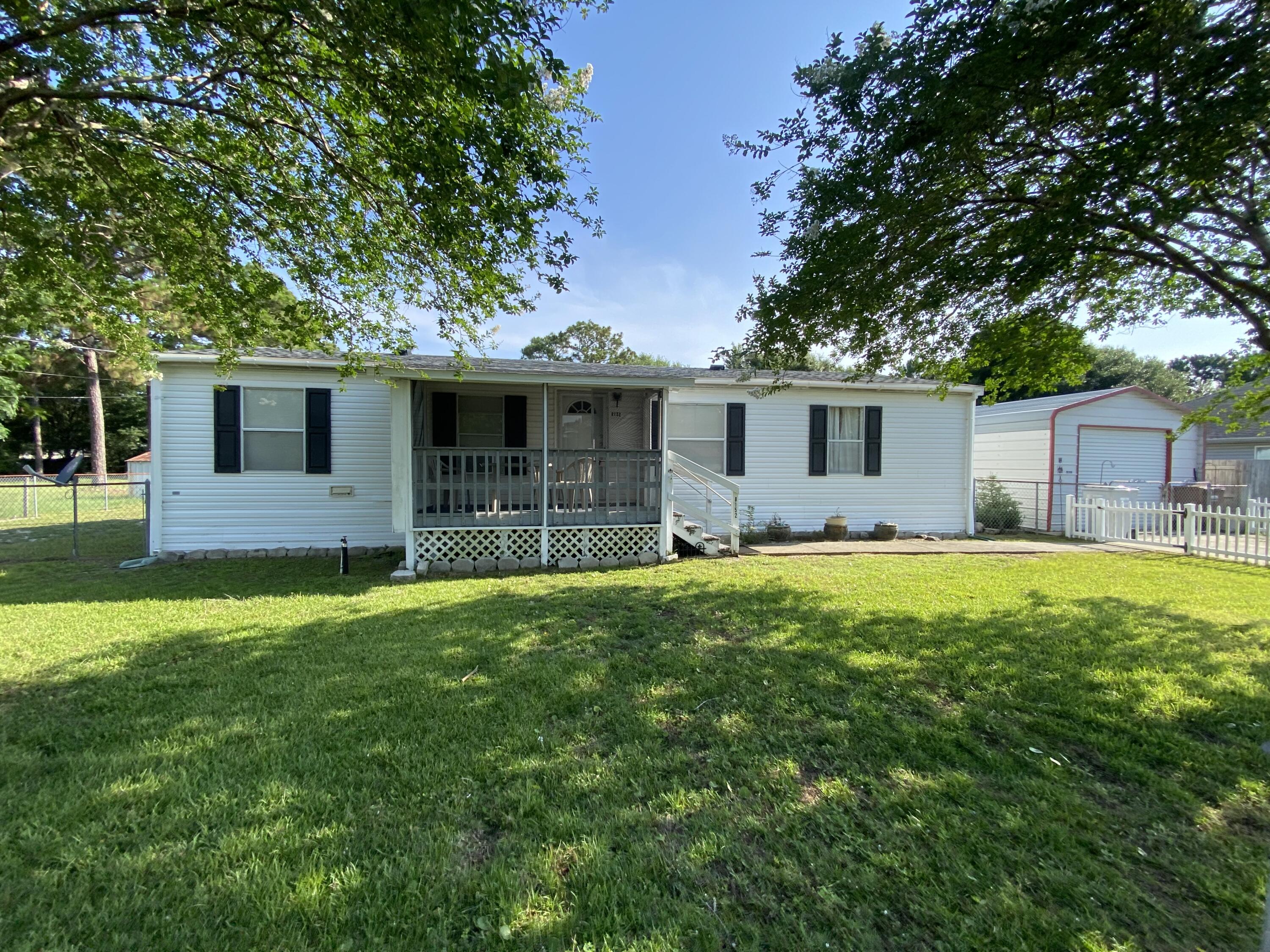 Spacious lot and flexible living! This 3-bed, 2-bath manufactured home sits on nearly half an acre with a detached garage and separate storage shed for added functionality. Inside, enjoy a split floor plan, large kitchen with included appliances, and a generous primary suite with walk-in closet. All appliances convey--including washer, dryer, and refrigerator. With ample parking, no HOA, and room to personalize, it's ideal for buyers seeking affordability and space. Located within commuting distance to Hurlburt Field and Eglin AFB, and close to schools, shopping, and Navarre Beach. Whether you're investing or making it your own, this one is priced to move!