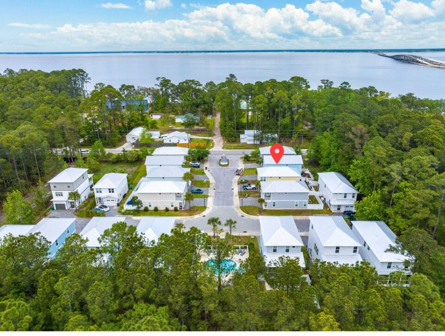 PRICED TO SELL! Discover this ray of sunshine! This charming and quaint community is located across from the bay with a boat launch near by! This captivating craftsman style home is conveniently located in the peaceful community of Lighthouse Pointe. Within just a few minutes walk, is a variety of local favorite Bay Front restaurants, with live music daily. Your new home is less than 4 miles from the pristine beaches of the Emerald Coast offering white sand beaches and emerald waters. The attention to detail and dedicated craftsmanship is evident in this 3 bed/ 2.5 bath home. This residence offers a thoughtfully designed layout with wood-like tile flooring on the main level and LVP flooring upstairs, ensuring both style and easy maintenance.The inviting living area seamlessly transitions