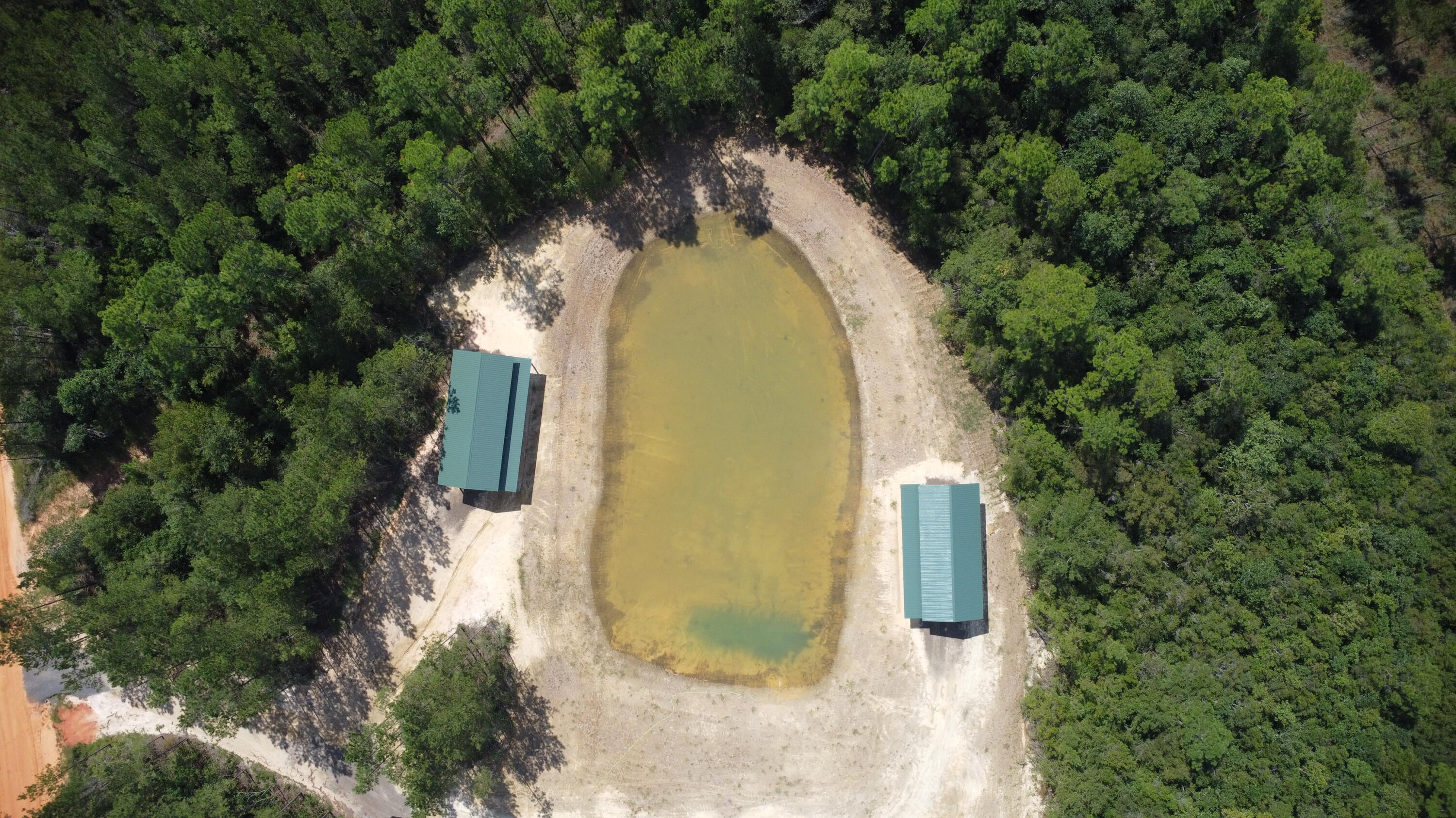 MASSIVE PRICE REDUCTION!!!Beautifully developed 18.24 acres in Milton Florida with two entrances! This property has THREE pole barns, 1-acre pond, electric, and TWO private wells. It's time to build your dream home in your own corner of paradise. Close to lakes, park, and more!