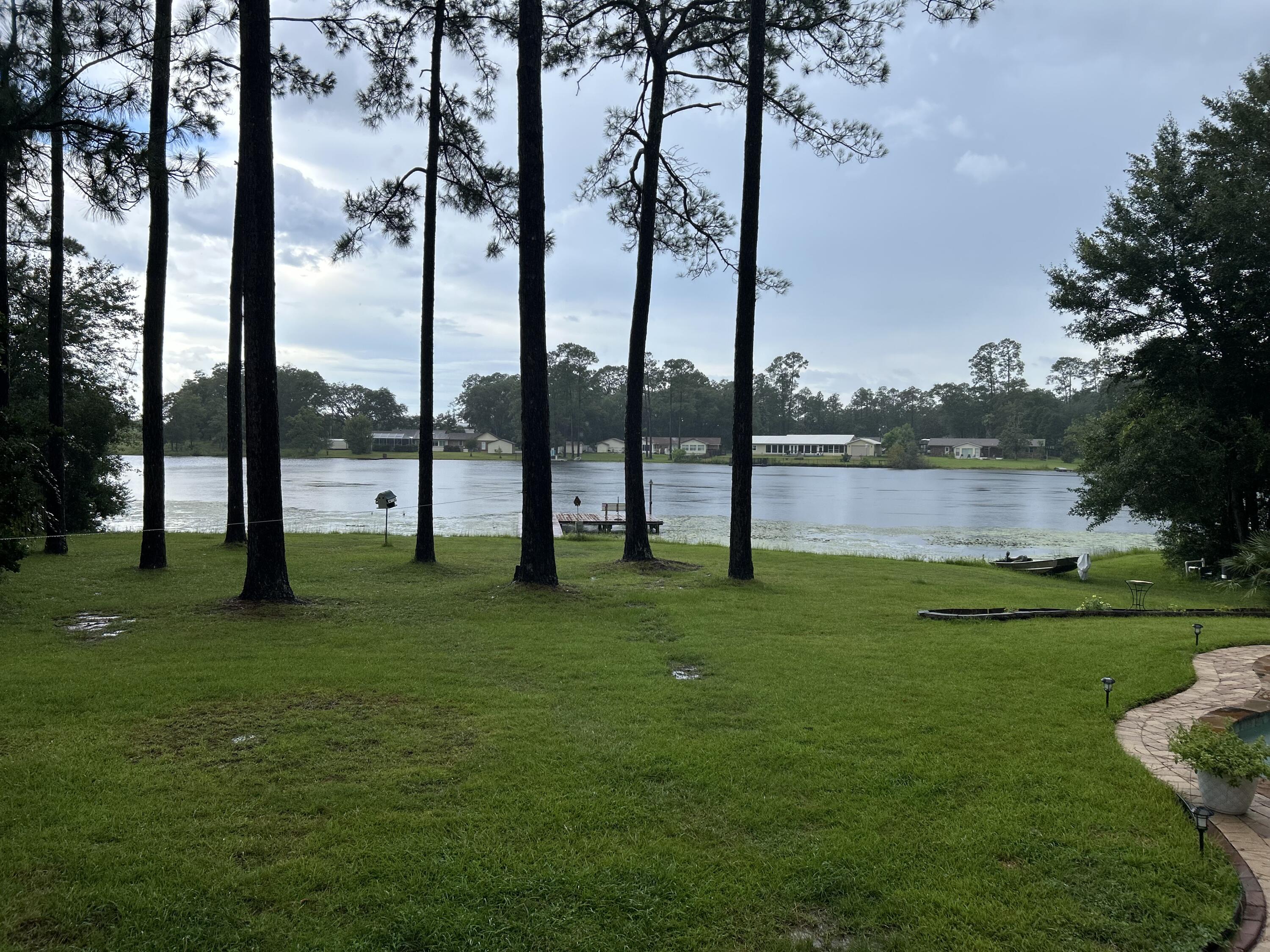 Lake front living south of I 10! Tucked away on just under 1.5 acres is this great country home close to it all. With 4 bedrooms, cozy stone fireplace in the family room, inground pool for summer enjoyment, workshop and your own privte deck on the lake is a rare find here in Crestview. Newer HVAC and roof and an amazing covered back deck that runs most of the way across the back of the house is greata for relaxing or entertaining. Exterior paint is upgraded to where you are never suppose to have to paint again..... Check that off the honey do list.... Great 24x16 workshop for the hobbiest or convert to an at home office. Not to mention a large covered front porch for additional outdoor retreat to enjoy. Green house with power also. This is a must see before you make your final decision.
