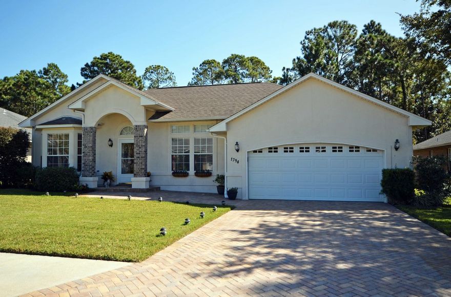 Immaculately maintained custom craftsman pool home in desirable Sound Hammock! Walk up the paver drive and enter the open and airy foyer. The home features light paint and tile floors in all common areas, bathrooms and the Master Suite. To your left and right are spacious office and dining areas. Continue into the family room and enjoy the natural gas fireplace with premium logs. Gaze out the French doors at your enclosed lanai, pool, hot tub with a glass rock propane fire pit! The pool and enclosure are only 2 years old and offer both shaded and open air sitting areas! To your right, pass through the kitchen with beautifully upgraded granite countertops, custom tiled backsplashes, newer stainless appliances, rich wood cabinetry, breakfast bar and breakfast nook. Continue down the hall,