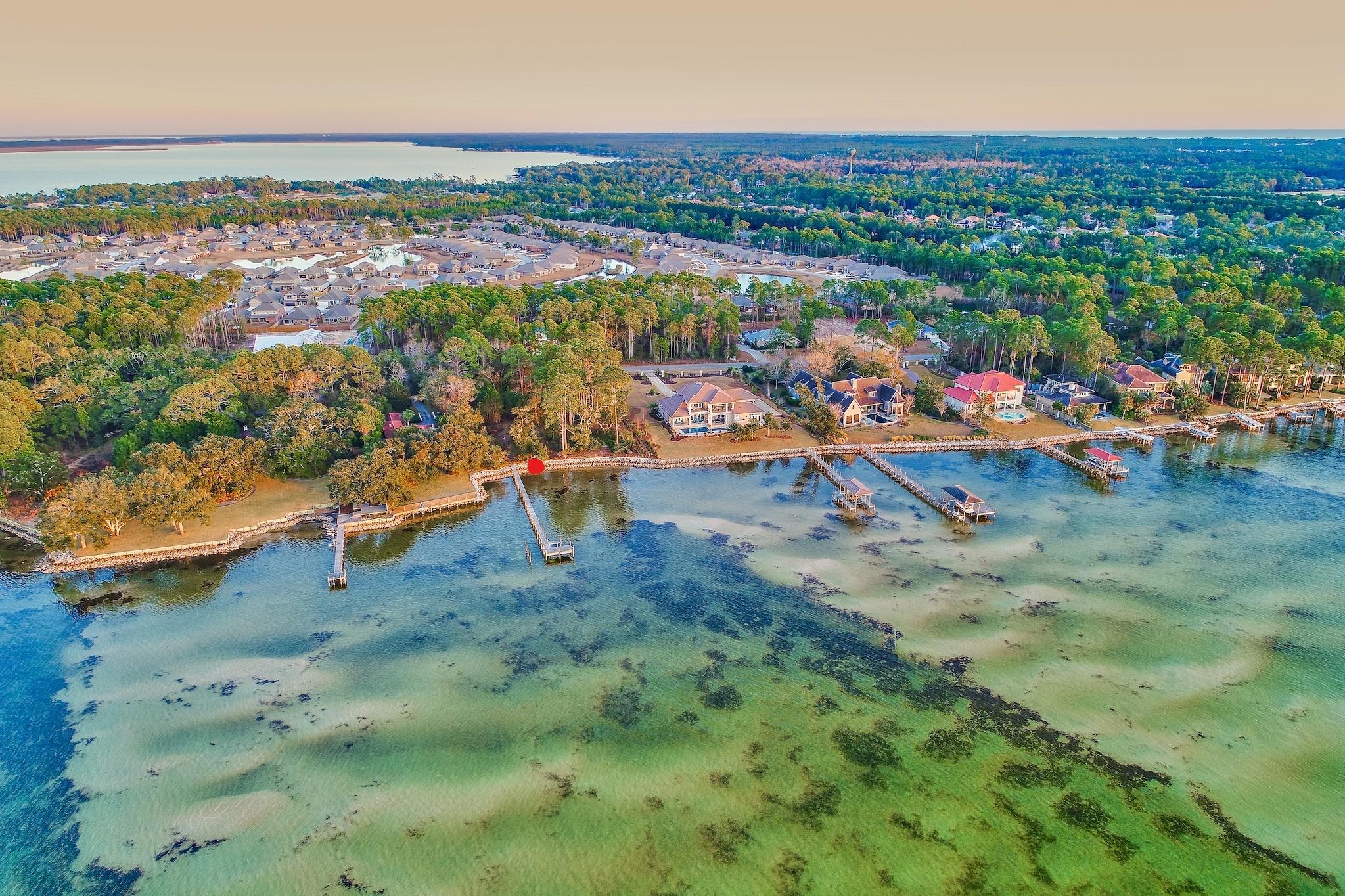 Incredible West Facing Sunsets is a great way to describe this gorgeous lot. It is high and dry, protected from the north wind, won't need extensive fill dirt, has never held any water from storms, has a solid rip-rap sea wall and a 150 ft dock.The lot has beautiful oak and pine trees and is surrounded by multi-million dollar homes. Use it now to keep your boat or jet skiis and build when you are ready. A short boat ride to Baytowne Marina to enjoy all the fun at the Village of Baytowne Wharf. Easy access to Destin Harbor, Crab Island, Bay Fishing and the East Pass for Gulf of Mexico access. Owner financing is available with 20% down.