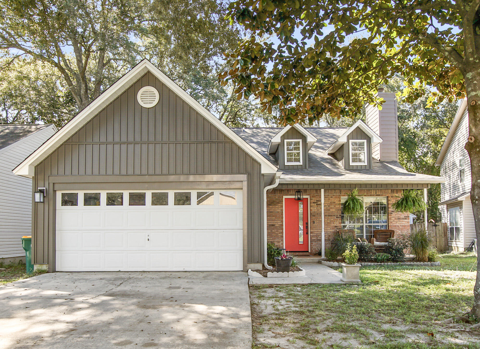 Welcome to this charming home in Indigo Village of Bluewater Bay! This meticulously maintained property reflects pride of ownership and is ideally located near shopping, schools, and the beautiful beaches of the Emerald Coast. The living room features vaulted ceilings and an abundance of natural light from dormer windows. The kitchen and dining area offer tile flooring, granite countertops, and plenty of space for entertaining. Step outside to the private backyard, where a spacious deck provides a peaceful setting to relax or entertain while enjoying the sounds of nature. The master bedroom, located on the first floor, includes slider doors leading to the fenced backyard and a walk-in closet. Additional storage under the staircase is perfect for a pantry or extra organization. Upstairs, you'll find two additional bedrooms, each with alcoves and built-in shelving, ideal for a home library or storage. The second bathroom features a double sink vanity for added convenience.
A bonus room, created by partially enclosing the garage, offers extra storage and includes a laundry area. The garage door remains functional, allowing space for yard equipment or storage. Major updates include a new roof and siding, both updated in 2023, providing peace of mind.
