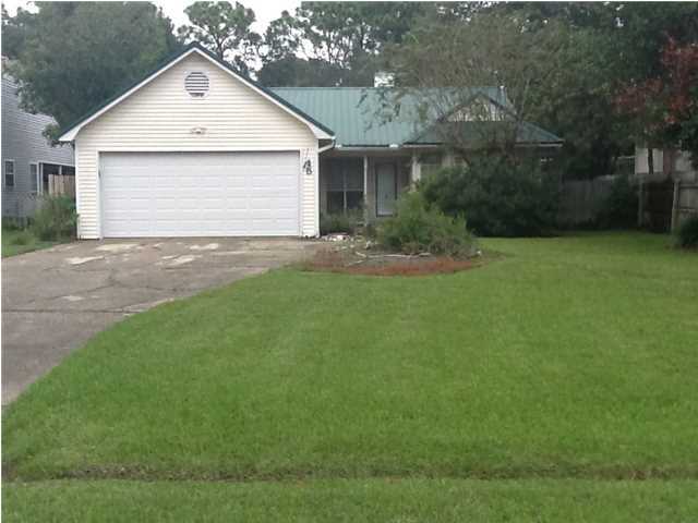 Previously Approved Short Sale Price - Drive only 5-10 minutes to Eglin front gate! This 3 bedroom/2 bath home sits on an incredible lot! The fenced in backyard is big! The garage door is storm rated for hurricanes! The home has a tin roof and due to the age of the roof the insurance cost are lower! Also, there is a 13 Seer 2006 Ruud Gas Heat and Electric System, Kenmore stainless and black stove and dishwasher, plus a lawn pump that waters both the front and back yards! Relax on a nice covered patio in a back yard that is approximately 155' deep! In addition, the kitchen and dining room floors are hard woods, the ceiling in the living room is a cathedral ceiling, and there is a wood burning fireplace (use it either way). The master bedroom is large and also features a master bathroom