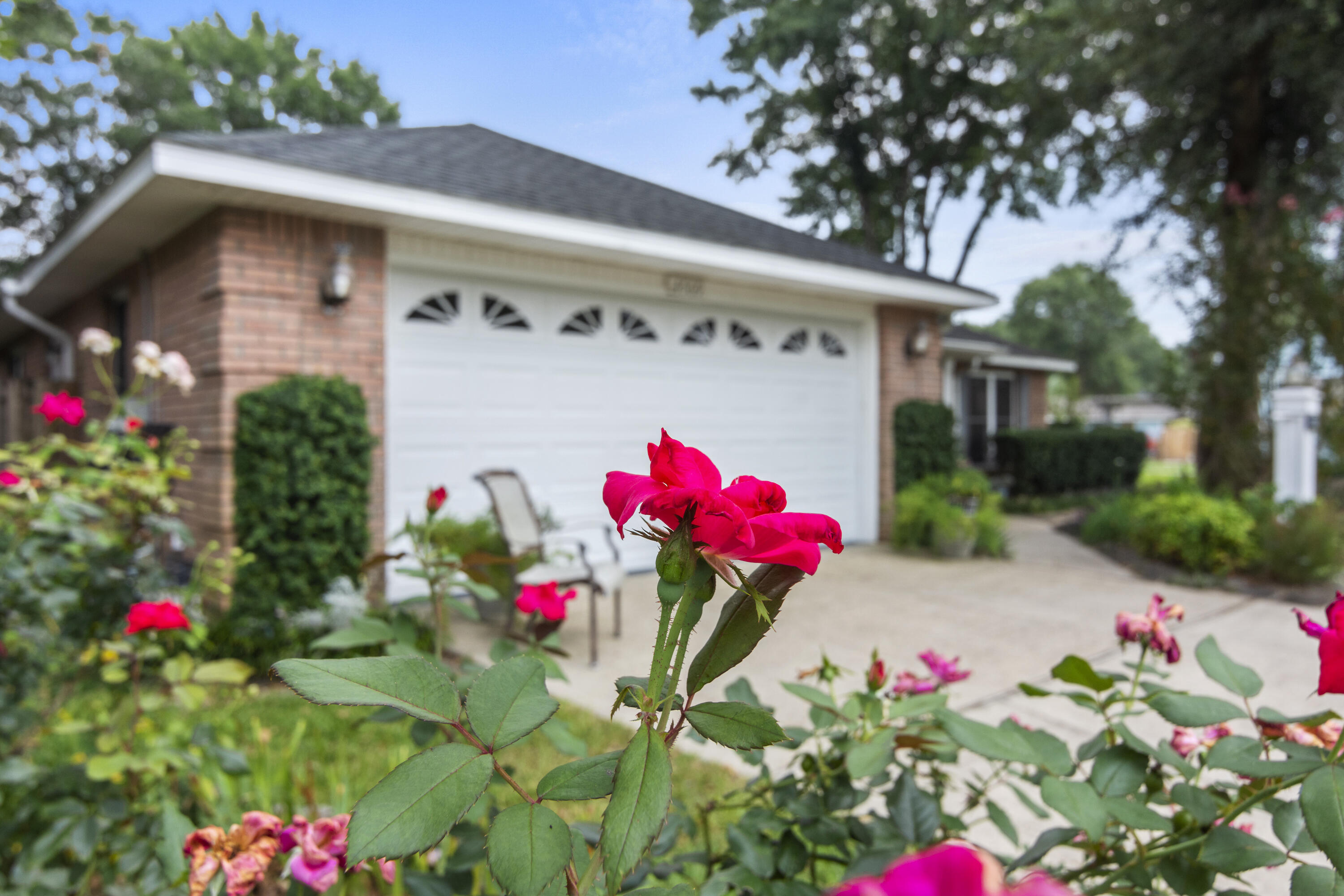 Located in THE ideal neighborhood in Crestview for access to all the bases, along with a heated pool, A/C controlled workshop and storage rooms, a baker's kitchen, and a yard that is a gardener's dream: this 4/2 updated split-floor plan house IS the home you've been waiting for! As you pull up to the large corner lot and double-car garage, the beauty of the extensive landscaping is evident right away with countless garden areas that bloom throughout the year, multiple citrus trees, and river rocks brought in from North Carolina! Instead of the garage, you may choose to pull into your custom carport that connects directly to the huge screened enclosure around the pool. Plenty of space all around to enjoy time outside with family and friends. Once you make your way inside, you'll love the cathedral ceilings, spacious bedrooms, and double-hung Pella floor to ceiling windows. Make your way into the kitchen and you'll fall in love with the duel-fuel Bosch oven with a five-burner gas stove-top and an electric oven for getting those cookies and cakes just right! There's also beautiful quartz countertops, a reverse osmosis water filter, custom cabinet storage and a hide-away microwave cabinet. Just off the kitchen, you'll step down into your heated and cooled Florida room with a huge TWELVE foot glass sliding door with a SIX foot opening out into the enclosed pool area (new pool screen this year)! Also, from the pool area, you can access your 200sq/ft cooled workshop and your separate 200sq/ft cooled storage room for all your big toys! Just outside the pool enclosure is a 12x10 garden shed (electric hook-up) with an adorable lean-to and patio. This established yard in an established neighborhood with no HOA fees, a heated enclosed pool, and a beautifully updated home on the very southern tip of town makes it one of a kind. Don't miss out!
Bonus! Are you looking to live next door to your best friends or extended family? The house directly behind the property will be available within the next couple weeks, and there is already a gate between the properties! Contact sellers agent for more info.