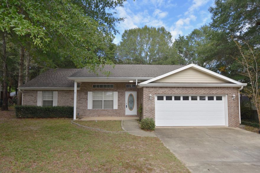 Attractive and affordable! This all brick home is located in a quiet subdivision on a low traffic street. 10' Raised ceiling in the Living Room and open floor plan has a country Kitchen with breakfast bar. Tiled flooring in the entry, Kitchen, Dining area and both bathrooms. Split bedroom design. Cultured marble vanities in both bathrooms + a cultured marble whirlpool garden tub with tile surround & glass block window in the Master bathroom. Oversized Master bedroom has a walk-in closet. Both sides and back are fenced by the adjoining owners so it should be easy to enclose the back yard for your little ones to play. 1 year home warranty provided by seller, $450 Value. 2-Car attached garage + 16x20 detached garage workshop with a single garage door. Oversized patio, deck + large front porch