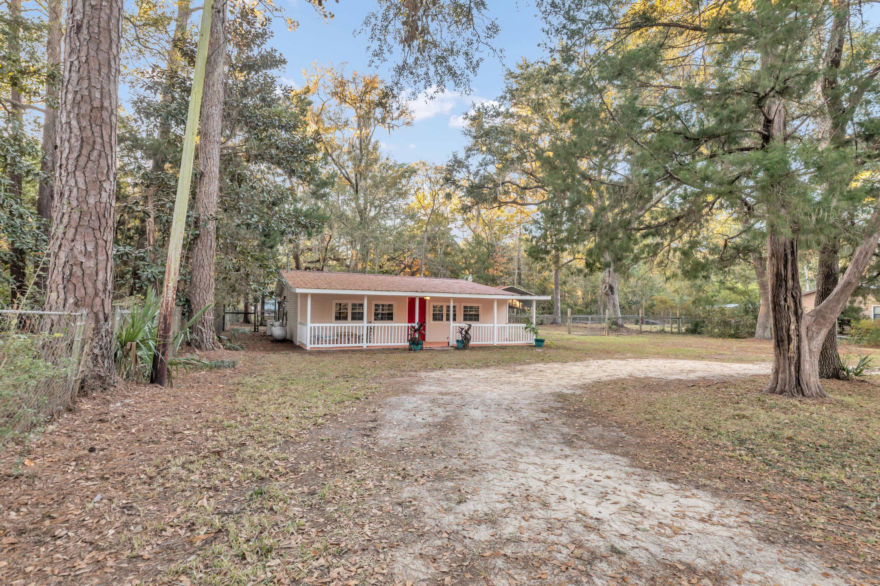 No HOA, almost a half acre. This fantastic home is situated on a double lot and is a fisherman's paradise. As you enter the home, you'll find the first bedroom to your immediate right, which features an en-suite bathroom. The additional bedroom is located across the hallway, to the left as you enter the home. As you continue down the hallway you're greeted with an open concept area that features the living room, dining and kitchen area.  As you continue to head towards the back of the home, you'll find a secondary full bathroom and additionally, a large storage and laundry area. with a large sunroom with windows added for an extra room overlooking the back yard and detached screened and covered back porch. Large fenced inbackyard features a covered parking area that is perfect for an RV, a 5th wheel trailer boat or car storage.
This property would make the perfect full time residence or weekend fishcamp! Located about 1 mile from the Black Creek Lodge & Marina. New metal roof 6 years old. A NEW BlueRidge MiniSplit was installed July 2020.  
All new piping throughout the entire home has been installed November 2024.  Close to bridge to the beaches!  