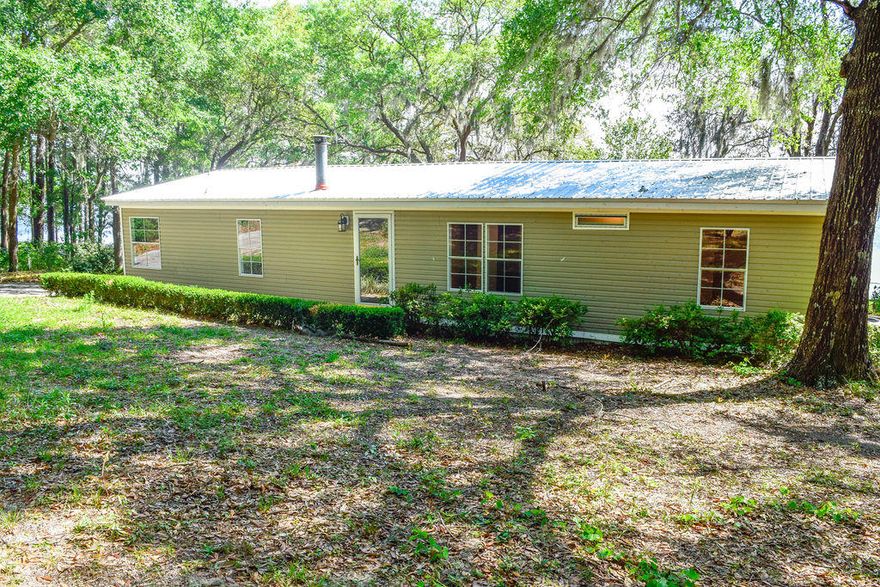 Come find your serenity in this beautiful lakefront home that is renovated like new! New floor covering throughout, new outside HVAC unit, new HWH and new metal roof. Front yard has landscaped flower beds. Concrete drive, fenced back yard, two storage sheds, and large back deck. Convenient to town. Large living room with decorative wood surround fireplace. French doors to Master bedroom and master bath. Master bath has two vanities and large closet. Split bedroom floor plan. Roomy kitchen with lots of cabinet space. New stove and refrigerator. Dining room and living room have lots of windows to enjoy the lakefront view. Fenced back yard. Large back deck. Dock for your fishing pleasure on Lake Juniper. Boat ramp on property could be rebuilt. This one won't last long!