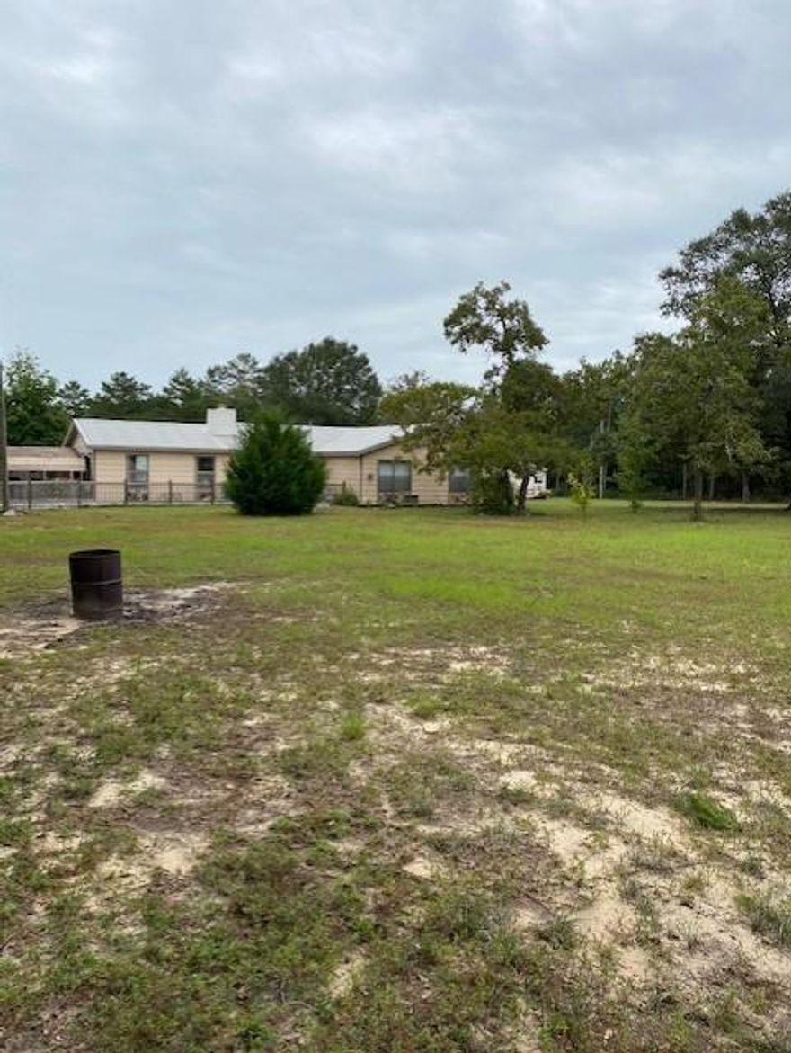 Loads of Potential! This home has a great floorplan, a metal roof,  3 outbuildings, a small greenhouse, and fruit trees! Tile and laminate flooring are in the main living areas and one bedroom - 2 bedrooms have carpet.  There is extra parking on the side of the carport and an RV electrical hookup in the backyard. Buyer to verify all measurements.