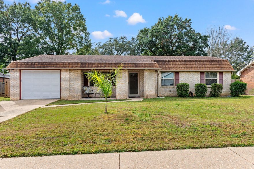 A PEACEFUL brick ranch set amongst a tree-lined lot located in Belvedere Park comes in PRISTINE condition and includes an array of wonderful updates.  You'll be sure to love the welcoming neighborhood that features a playground, walking paths, and gazebo where you can enjoy daily strolls and beautiful weather and a short drive to much of Pensacola!  This well-built HOME features a nostalgic aesthetic with its gable roof, picture perfect shutters, and large lot that is accented with shrubberies and mature trees. Your welcomed inside to a quaint floorplan that features two living spaces. The main living area is warm and inviting and features a large window, wall to wall carpet, and a ceiling fan. You'll feel right at home amidst the laidback living space as you cozy up on a sofa, reading
