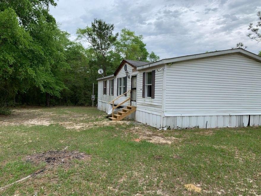 REO. Large Lot - over 6 Acres of secured property located off of Hwy 1087 in DeFuniak Springs. Want the Farm Lifestyle? You can have it! Plenty of room for Horses, Chickens, Barns etc! 3 bedroom 2 bath mobile home on site in addition to a large workshop/shed. Call for more information!