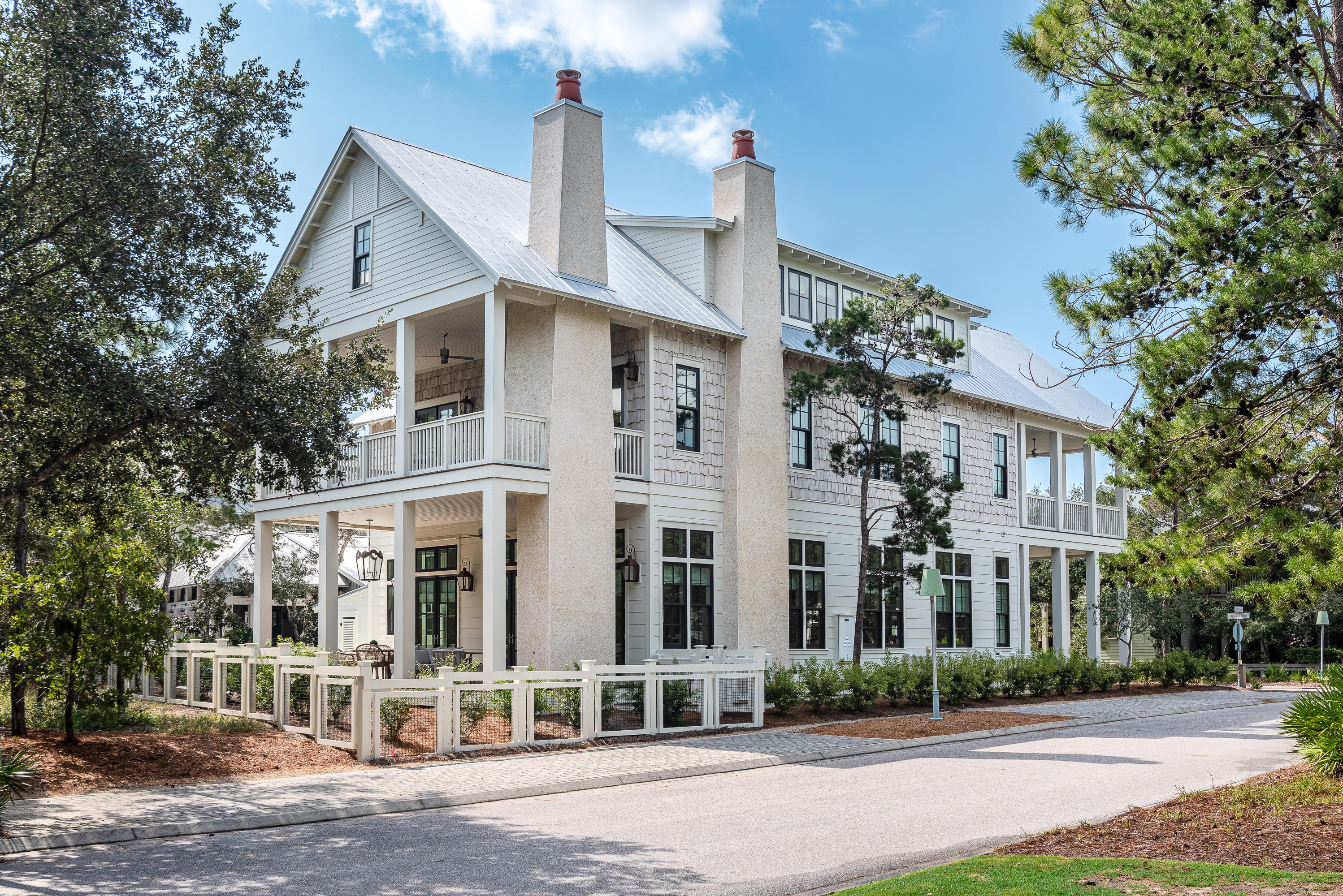 Light and space define this immaculate, newly-constructed luxury beach home.  Situated on an oversized corner lot, with preserve land to the rear and a pedestrian greenway across the street, the house at 42 Flatwood presides over one of the community's most enviable locations. 12' ceilings on the first floor and a warm shade of white paint, along with an extensive number of transom windows, lend an ethereal feel to an already superbly decorated living area.  Boasting six bedrooms, each with their own en suite bathroom, across 5,552 square feet of conditioned space, very few homes in the community are larger than this one.  None are as beautiful.  Attention to detail in construction extends to tile and other selections.