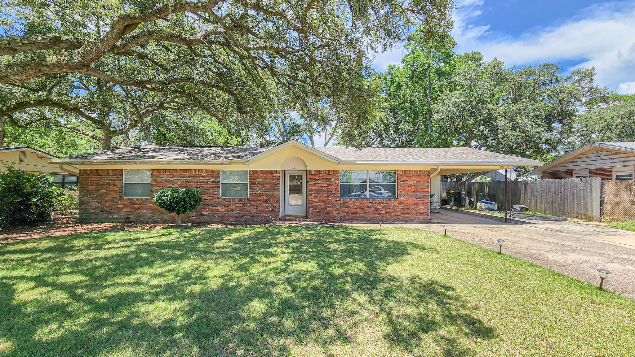 Charming single story brick home in centrally located FWB, with beautiful PRIVATE IN-GROUND POOL. ROOF 2018, HVAC 2006 (self-cleaning, no monthly filters!) WATER HEATER 2019. Inside, you'll appreciate the bonus living space with large front window, and through the kitchen is another open dining and living area with brick statement fireplace, which you could have as a formal or informal space. Off the dining area is the laundry and storage room, and door that leads you to the carport. Back inside past the kitchen are 2 guest bedrooms, full guest bathroom, and master bedroom suite - complete with full bath and walk-in closet. LARGE FLORIDA ROOM - with two access points (kitchen and master bedroom) to relax and enjoy your backyard oasis. SEE MORE -->