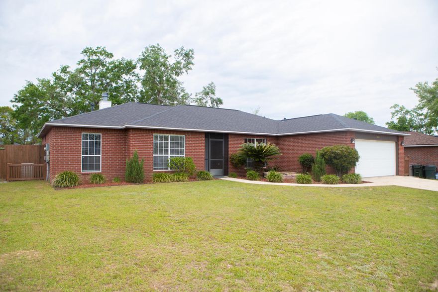 This beautiful crimson red brick home with many updates has 4 bedrooms, 2 baths, and 2016 sq ft and is located in the desirable Magnolia Lake Estates in Cantonment, FL.  The home was built in 2002 yr and features a brand new roof (2020)! Enter the home through the screened front patio and leaded glass front door notice the vaulted ceilings, gas fireplace, shiplap walls, and plant ledges in the living room! The living room opens to the kitchen. The kitchen has an eat-in dining area overlooking the backyard and outdoor kitchen! This kitchen features custom wood (Maple) cabinetry with crown, brushed nickel hardware, new quartz counter tops (2021) and kitchen sink and faucet! There is a center work island for additional preparation and counter space! The appliances are stainless and black and feature a French Door refrigerator, new microwave (2021). There is also a great pantry in the kitchen! There is a formal dining room that could also be used as a home office or play room! The home has a split floor plan with the master bedroom on one side and three guest bedrooms on the other side of the home! The master bedroom is large and has a new ceiling fan and large 5 piece en suite bathroom. The master bathroom has new quartz countertops on the double vanity, new faucets and fixtures, new mirror, lighting, a soaking tub, separate walk in shower, and water closet! In addition, there is a very large walk in closet with shelving! The guest bedrooms are spacious and also feature new lighting! The guest bathroom has a new vanity, mirror, lighting, flooring, brushed nickel hardware, faucets and fixtures! This home has laminate flooring and travertine in the wet areas. The garage is oversized and has built in shelves and cabinetry! There are sliding glass doors in the living room that open to the open patio with slate tile! Entertain your guests with this amazing outdoor kitchen with gas grill and arbor! The arbor creates a nice shady area for cooking and entertaining! The yard is fenced with a privacy fence and large enough for a pool to be installed! The soffit and fascia on the home was replaced in 2017 yr, along with the plumbing! There is Pex plumbing! There is also a great storage area that is fenced in on the side of the home! Buyer to verify all dimensions and information.