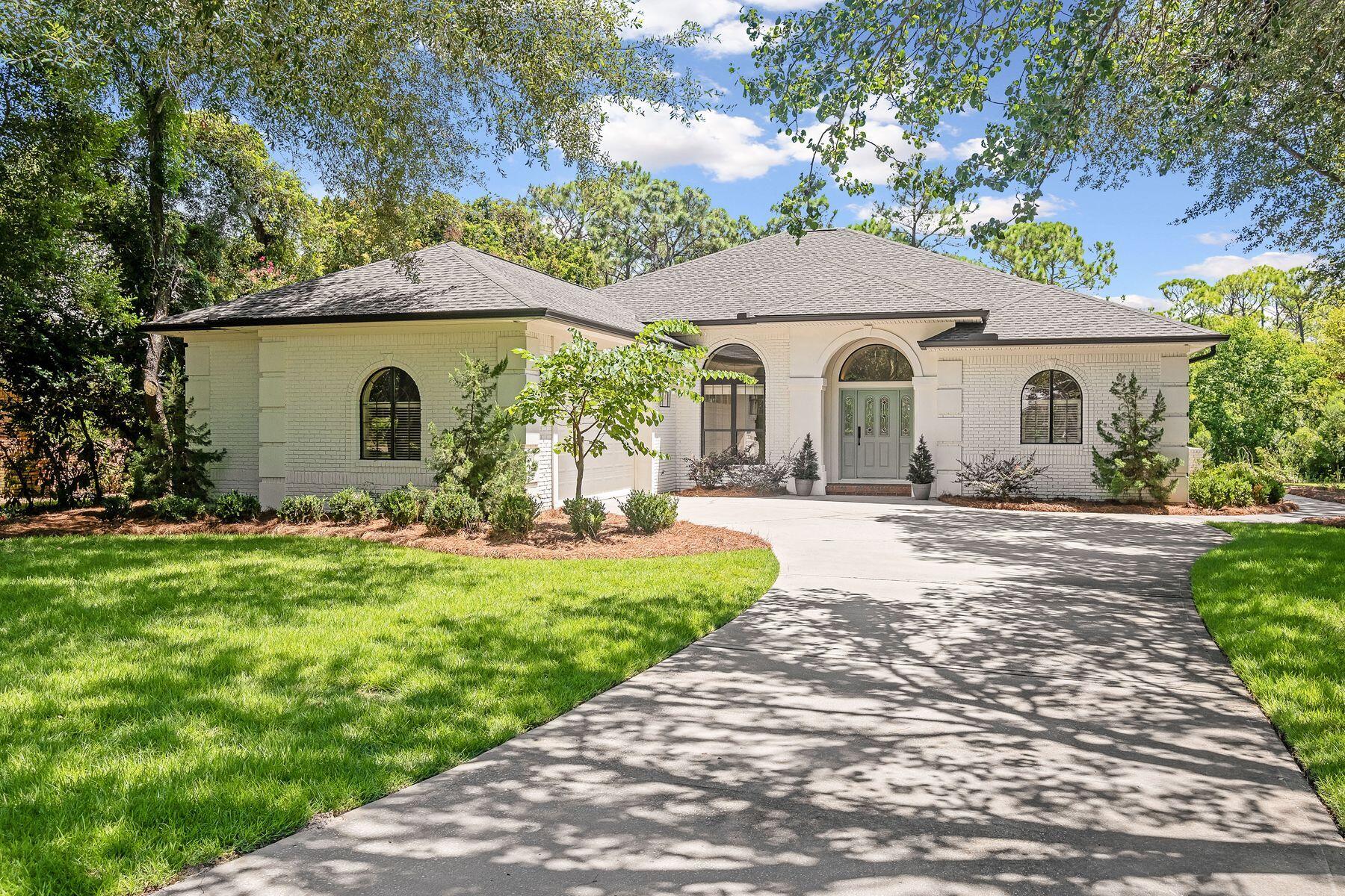 Set on a generous .41-acre lot within the exclusive gated enclave of Kelly Plantation, this refined single-level home offers both privacy and connection to nature with its peaceful backdrop of lush, protected preserve. Built with enduring quality, the residence features brick over concrete block, a 2021 shingle roof, water heater, HVAC and modern interior updates. The welcoming foyer opens to airy, light-filled living spaces, including a gourmet kitchen with shiplap accents, quartz countertops, a monochrome island, and abundant cabinetry. Ideal for casual mornings or lively gatherings, the kitchen flows into a sitting room anchored by a modern horizontal fireplace. A formal dining room and a versatile bonus room provide options for entertaining or everyday living. The split floor plan offers four spacious bedrooms and two stylish baths. The master suite enjoys serene preserve views through oversized picture windows, with an ensuite bath featuring a soaking tub, frameless glass shower, and striking herringbone tile work. Outdoors, a thoughtfully cleared backyard with room for a pool, creates space for an inviting seating area with an outdoor fireplace, summer kitchen, Big Green Egg and fire pit - perfect for quiet evenings or festive gatherings. Just beyond your doorstep, residents enjoy a wealth of community amenities, including an award-winning golf course, owners' clubhouse, fitness center with yoga studio, tennis and pickleball courts, riding stables, basketball and beach volleyball, community docks, playgrounds, and scenic walking trails. With the middle school a short stroll from the back gate and a new high school nearby, this move-in ready home pairs comfort, convenience, and an enviable lifestyle in one of Destin's most sought-after communities.