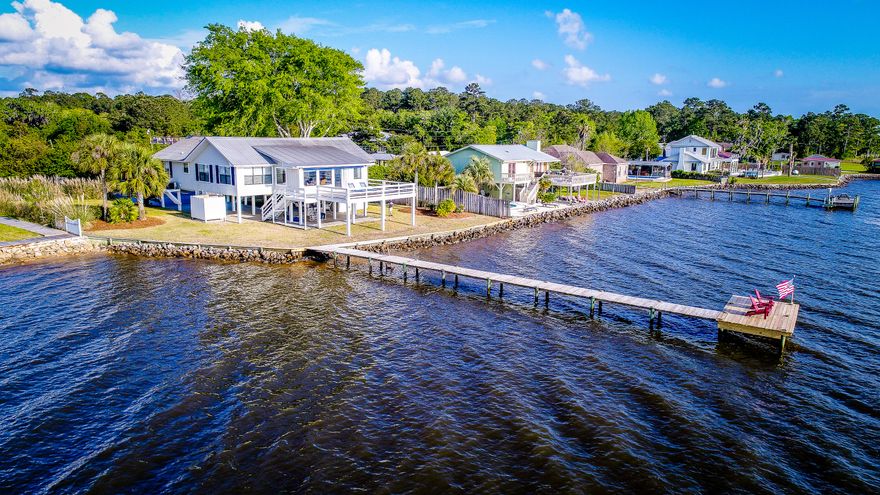 The quintessential Bay Front retreat! From the moment you pull in the driveway, of this Old Florida Cottage, stress melts away. Stepping in the front door you are met with Panoramic Bay Views and an open concept living room/dining room/kitchen area. The 3 bedroom split floor plan includes a bayfront master bedroom.The outdoor living space is incredible! The open back deck is 21'x 24' and the perfect spot to soak in the afternoon sun or the breathtaking sunset views. The home is built on pilings offering covered parking and a shaded area for lounging with morning coffee or afternoon hammock naps by the bay. The outdoor shower & bathroom are great for entertaining.This home is a must see!