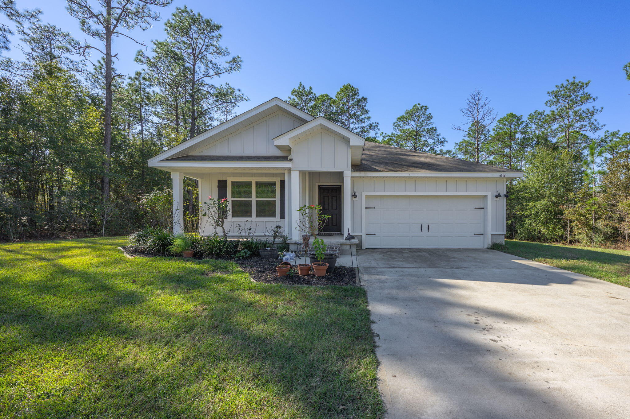 SHORT SALE This 4-bedroom, 2-bathroom home in Heritage Plantation, Laurel Hill, features a practical Cali floor plan. The home has a covered front porch and an open living space with durable luxury vinyl plank (LVP) flooring in the main areas and carpet in the bedrooms.The kitchen includes white cabinets, stainless steel appliances, an island for extra workspace, and a pantry for storage. The primary suite has a walk-in closet and an attached bathroom with a double vanity and walk-in shower. Three additional bedrooms and a second full bathroom provide additional space.Outside, the covered back patio offers a view of the backyard. The two-car garage provides parking and extra storage. Situated in Heritage Plantation, this home is available for those seeking a straightforward layout and functional design. Contact us to schedule a showing.