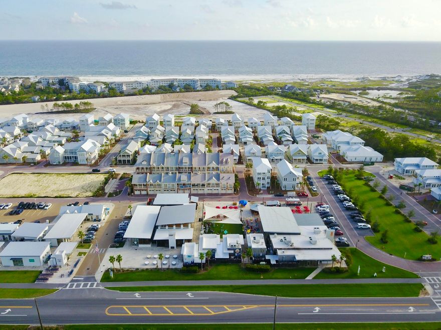 Completed in October! Upgrades include hardwood floors, astoria granite and bisque soft close cabinets throughout. Open floor plan with six windows lining the living space opening to a large covered balcony which can be screened in after closing. The gourmet kitchen includes stainless steel appliances, crema carfil classico limestone backsplash and stainless farm sink. Crown molding and tray ceilings can be seen throughout. The master bathroom will be finished with linden point beige 12x24 porcelain tile, dual vanity sinks, large walk-in closet, and a frameless glass shower door. Across from ''The Hub'' which features shops and multiple dining choices. Amphitheatre and Jumbo Tron light up the night with live music, movie nights, sporting and highly televised events.