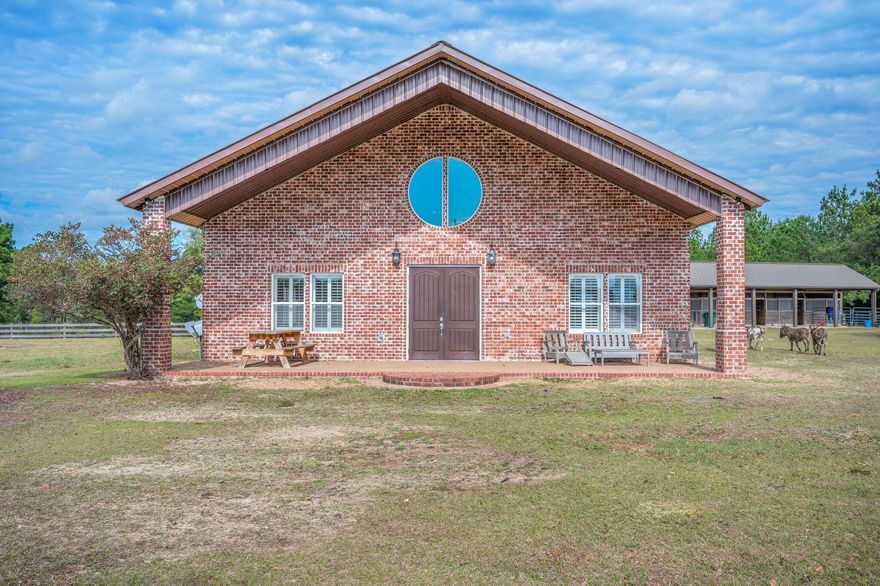 You've probably heard people talk about how special a show horse is--this home is the real estate equivalent of a true show home. The property is cross-fenced into four pastures, ideal for livestock and easy rotational grazing. Towards the back of pasture one you will find your one of a kind custom home featuring rustic wood finishes, a large open layout, cathedral ceilings, and peaceful country views. Outside features a 4-stall horse barn with space for tack and feed, along with a separate hay barn for additional storage, and a massive pull through garage for all your personal or farm life needs. Whether used for farming, horses, or recreational enjoyment, this property provides functionality, privacy, and versatility all just a short drive to the white-sand beaches of the Emerald Coast.