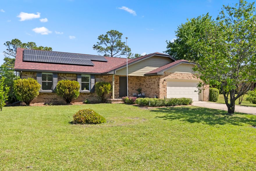 Charming Brick Home on Spacious .73-Acre Lot. 
Nestled in the highly sought-after Holley by the Sea, this beautifully renovated 3-bedroom, 2-bathroom brick home offers 1,448 sq. ft. of comfortable living space on an expansive .73-acre lot. Thoughtfully updated by its current owners, this home blends modern updates with timeless charm. Notable upgrades include a new roof (installed May 2021) and fully paid-off solar panels (installed July 2022), ensuring energy efficiency and reduced utility costs.

Inside, an inviting open-concept layout is accentuated by a vaulted ceiling in the living room, enhancing the sense of space and light. Stylish LVP flooring flows throughout, adding elegance and durability. The split-bedroom floor plan ensures privacy for all. The heart of the home is the spacious kitchen designed for both gatherings and everyday living, featuring a large breakfast bar with ample seatingperfect for casual meals and entertaining.  The primary suite offers a private retreat with a walk-in shower in the en-suite bathroom.
Step outside to a screened-in patio, perfect for year-round enjoyment. The fenced backyard with a double gate provides privacy and plenty of space to expand, garden, or simply relax. An irrigation system that keeps the lawn lush without added water costs.
This home has been used as a second residence, and the gently used furnishings are negotiable. Conveniently located near beaches, shopping, restaurants, and military bases it offers both tranquility and accessibility.
As a resident of Holley by the Sea, you'll enjoy exclusive access to the 45-acre private recreational center, featuring:
 8 clay tennis courts
 3 swimming pools
 Full gym & aerobics studio
 Lighted basketball courts
 Sauna & steam room
 Playground & game room
 Community clubhouse on Santa Rosa Sound
 Dock & East Bay boat launch
 Year-round community events

Don't miss this rare opportunity to own a beautifully updated home with incredible amenities and a prime location!