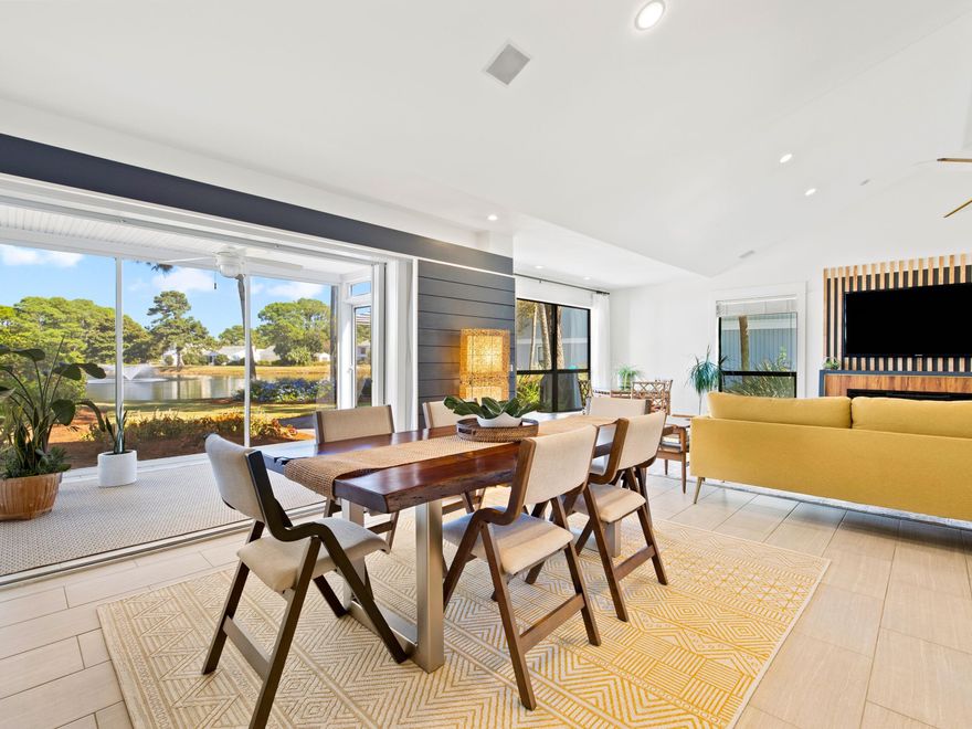 Nestled in the Sandpiper neighborhood of Sandestin Golf and Beach Resort, this beautifully renovated home has a superb open floor plan and tranquil lake views. Sold fully furnished, this tasteful condo has practical tile and laminate flooring and eye-catching feature walls. Vaulted ceilings and multiple windows create an abundance of light in the sitting and dining areas. Slide back the fully retractable glass doors to create a seamless flow onto the screened porch when entertaining. The paved patio invites you to relax, soaking up the peaceful surroundings and watching birds wading around the reflective lake. Enjoy the generous kitchen, defined by a large island with bar stools, for breakfast before heading out for your tee time. Custom Shaker-style cabinetry includes deep drawer storage, and there's a large pantry and floating display shelves. New stainless steel appliances, quartz counters and a double apron-front sink are complemented by the down-to-earth painted backsplash. Three generous bedrooms include an enviable master suite with vaulted ceiling and water views. Snuggle down in the sitting area for some quiet time with a book or a cup of coffee. There's ample closet space and a beautiful master bath boasting attractive tile, dual vanity and a walk-in rain shower with an additional hand-held faucet. Two further well-sized bedrooms and a renovated family bathroom with quartz-topped vanity make this property ideal as a permanent residence, vacation home or short-term rental.  The separate laundry room has an elevated washer and dryer and more storage.  There's dedicated parking for two cars or a golf cart at the front along with an exterior storage closet for bikes and beach toys. Head out to enjoy the endless amenities in the 2,400-acre resort that includes miles of deeded white sandy beach, four golf courses, a marina and watersports on the bay. You rarely want to leave the resort as there's excellent shopping and dining on Grand Boulevard and the Village of Baytowne Wharf.