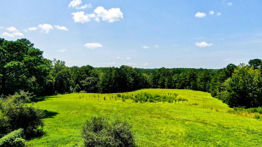 Truly a dreamy slice of heaven on this beautifully, gently rolling 10 acres with a large creek - PLUS ELECTRIC & DEEP WELL. There's a barn near the front with plenty of room to build your dream home elsewhere on the property. Wooded perimeter for privacy. Roughly the front half is cleared in pasture and the back half is wooded towards the creek. Partially fenced and located on a paved road just 5 minutes to historic DeFuniak Springs. Camper on the property also conveys. Rarely do parcels like this come on the market so don't wait to snap this one up!