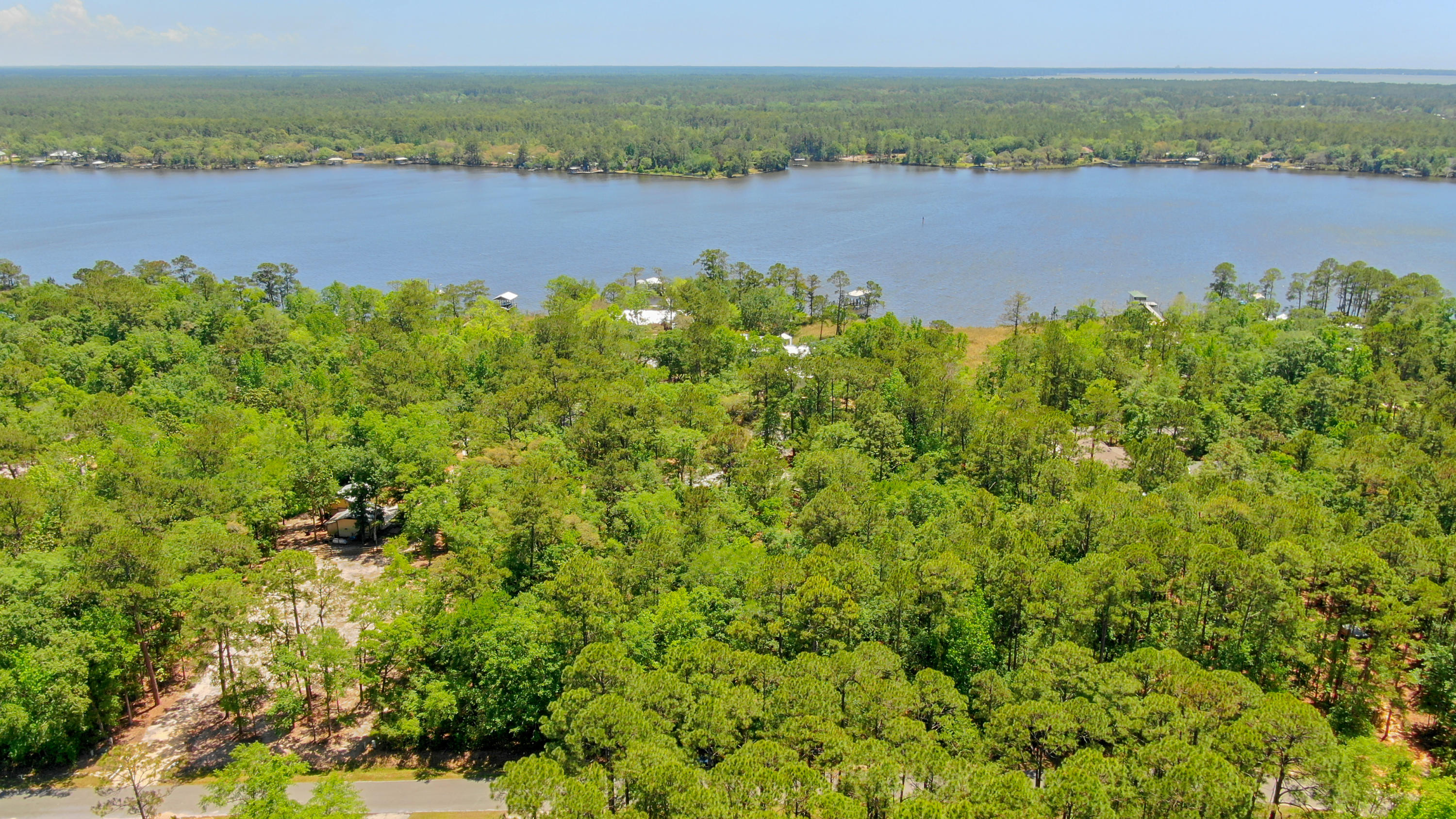 A large private and secluded lot for a beautiful home in a quiet neighborhood in Lagrange Shores. Tucked away from the traffic but close to restaurants, shopping, and the beautiful beaches of the Emerald Coast. NO HOA fees!!!