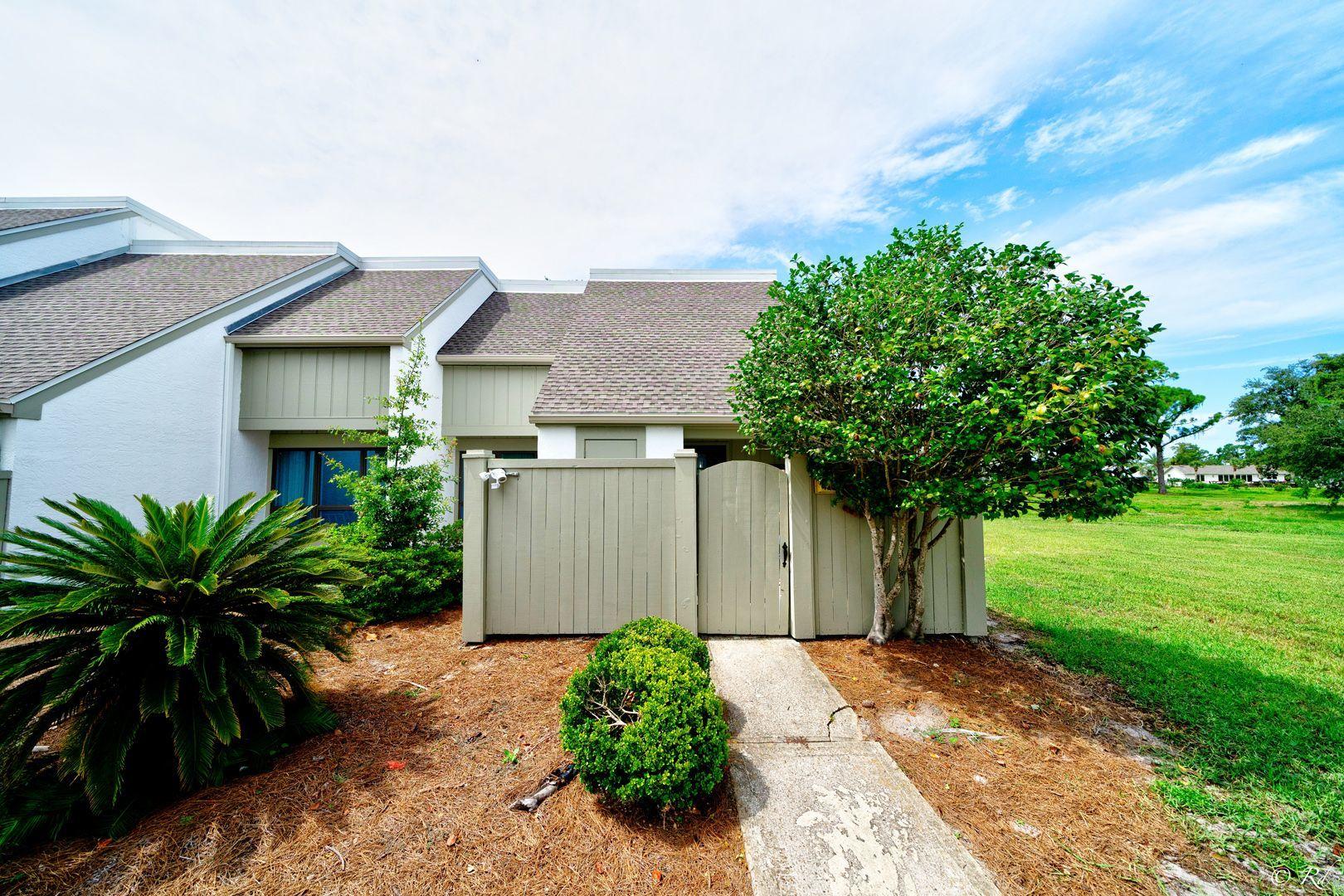 2 bed, 2.5 bath townhome in the desirable, peaceful gated community of Bay Point. This end unit welcomes you with a gated entrance securing the front courtyard area. This home has a large living area with updated LVP flooring and a plethora of windows to draw in natural lighting. Off the living area is a spacious, sunk in den with a view of the golf course and sliding glass doors that lead to the back patio. The kitchen is equipped with stainless appliances, plenty of cabinets for storage, and a breakfast bar. The dining area has a mirrored wall and also has sliding glass doors to the back patio, creating a seamless indoor/outdoor area for hosting friends and family. There is a half bathroom downstairs for convenience. There is also a coat closet and a storage area under the stairs for