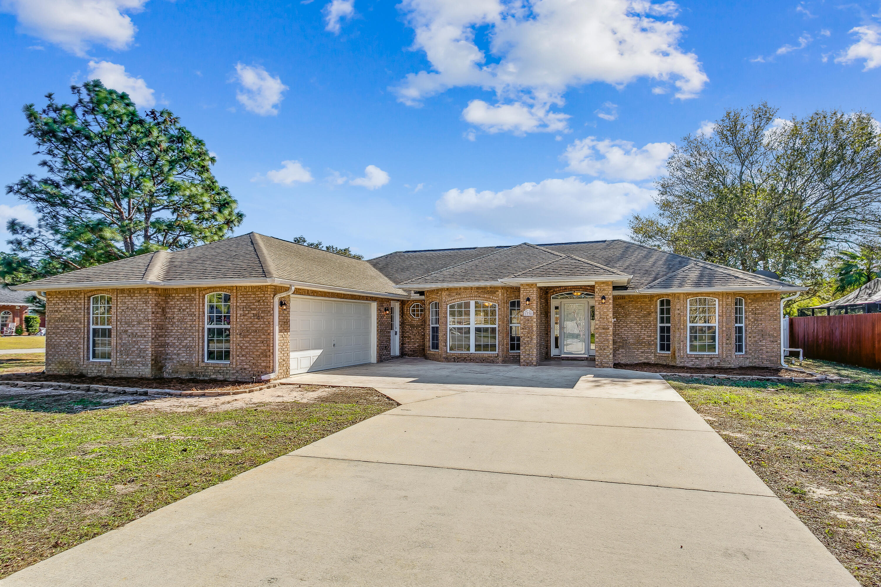 Fully UPDATED! NEW Floors, New Countertops, New Appliances, and MORE! This home provides an open functional floor plan, with ample storage in the 2-car garage and workshop. Located in the quiet and cozy neighborhood of Quayside Village in Gulf Breeze minutes away from A+ Schools, restaurants, shopping, Pensacola Beach, and Navarre Beach. As you walk through the front door you are greeted with a spacious great room/living room that flows freely into the formal dining room, breakfast nook, and kitchen. The kitchen boasts a large island with bar seating, all new appliances, and new countertops. The split floor plan gives perfect separation from the master bedroom and the two additional bedrooms. The master suite includes a massive walk-in closet, double vanity, garden tub, separate shower, and a unique private back porch seating area. The other two large bedrooms have their own walk-in closet, and share a full bathroom. The beautiful private backyard is equipped with a fully screened in 4 seasons Florida room, covered porch with swing, and also has a workshop. The LARGE corner lot allows you to spread out and could provide parking for your RV and/or boat. Schedule a showing today, it will not last long.