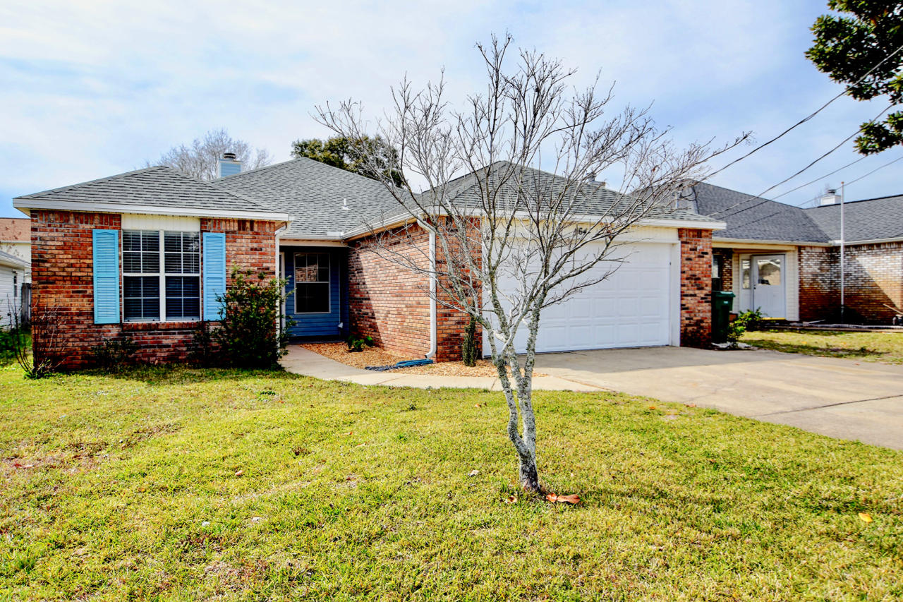Great home in a wonderful neighborhood with close proximity to Hurlburt Field, Mary Esther, and Fort Walton Beach. This home has many new features including new vanities, mirrors, and lighting in the bathrooms throughout. New carpeting has also been added to one of the guest bedrooms. The kitchen features stainless steel appliances, solid surface countertops, and tile flooring. The back yard is complete with a detached storage shed. The home features a 12.9 x 12.1 covered back porch, which leads tofenced in back yard, with abundant space to utilize and enjoy! Glass window panes currently being updated!. Come home and cozy up to the wood burning brick surface fireplace in your spacious new living room!