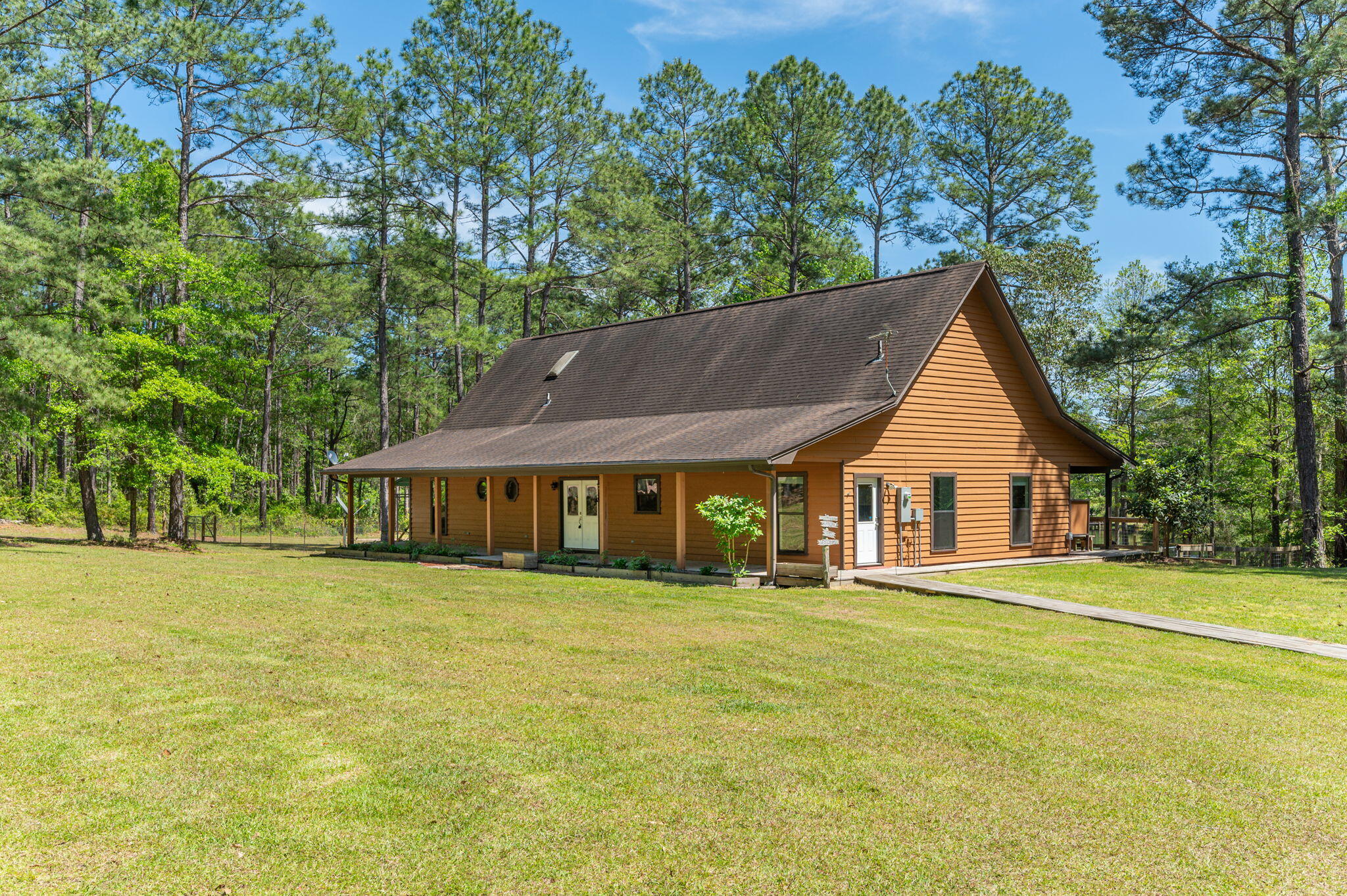 Seeking that Country Getaway from all the hustle and bustle without sacrificing the commute to local bases, beaches, and shopping centers? Well then, this 4-bedroom 3 bath home on 3.1 acres is ready for you to call it ''Home-Sweet-Home''. Property has two access points of Old River Road. Step in and you will right away be drawn to the floor to ceiling massive fireplace to keep you cozy during the cool months. Accented tongue and groove ceilings, wood and ceramic tile floors are just some of the appealing features of this home. The open floor plan provides the ideal location to entertain family and friends. Kitchen boasts ample butcher block counter space and cabinet space to meet all your cooking needs along with the black stainless-steel appliances. Split floor plan allows privacy as