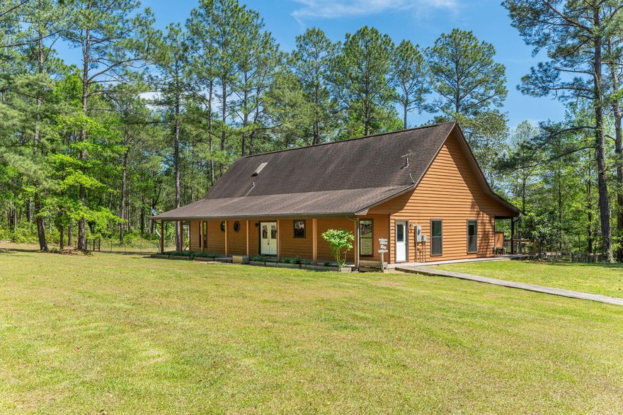 Seeking that Country Getaway from all the hustle and bustle without sacrificing the commute to local bases, beaches, and shopping centers? Well then, this 4-bedroom 3 bath home on 3.1 acres is ready for you to call it ''Home-Sweet-Home''.  Property has two access points of Old River Road. Step in and you will right away be drawn to the floor to ceiling massive fireplace to keep you cozy during the cool months. Accented tongue and groove ceilings, wood and ceramic tile floors are just some of the appealing features of this home.  The open floor plan provides the ideal location to entertain family and friends. Kitchen boasts ample butcher block counter space and cabinet space to meet all your cooking needs along with the black stainless-steel appliances. Split floor plan allows privacy as