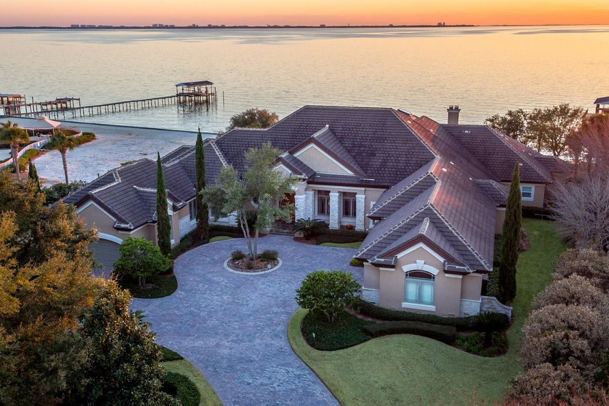 A very special home! The incredible lot is nearly 1 acre with 160 feet of waterfront on Choctawhatchee Bay. Located in Bluewater Bay's Sunset Beach community, the location provides a serene and secure backdrop for a quality lifestyle of making long-term memories!From planning to choice of materials to careful execution, the home exhibits exceptional attention to beauty, practicality, structural integrity, and meticulous details. The incredible foyer features an exquisite groin ceiling and 5-piece Versailles pattern marble flooring imported from Spain, which continues throughout the common areas. It opens to the formal living area with its fabulous views and soaring 15' 2-step coffered ceiling, as well as to the formal dining room which showcases a stunning ribbed barrel ceiling and