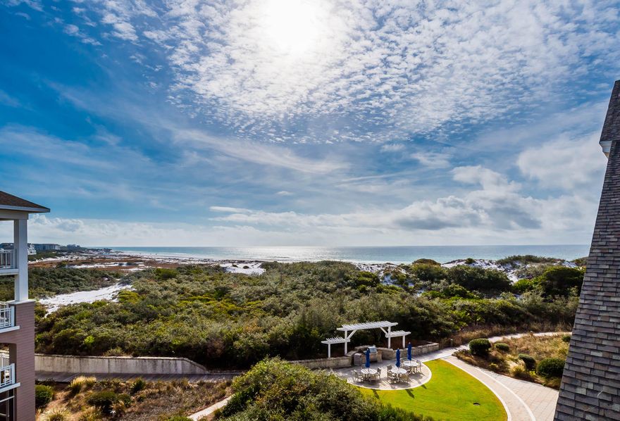 Nestled in the dunes of WaterSound Beach, this Compass Point beach condo brings gulf front living to a new level. With an open concept floor plan, this 2 bedroom, 2 bath retreat offers a resort-style living experience that is unrivaled along the beautiful emerald coast. As you enter the condo, your eyes are drawn to the beautiful cathedral ceilings, vast bay window featuring forever gulf views, and walls complimented with wainscoting. The kitchen is finished with granite counter tops, GE Monogram Series stainless steel appliances, Bosch dishwasher, and an expansive breakfast bar that opens up to the dining area featuring a custom solid wood table that will accommodate the entire crew. Off of the dining area, you will find a guest suite with two queen beds, tray ceilings, and a breathtaking