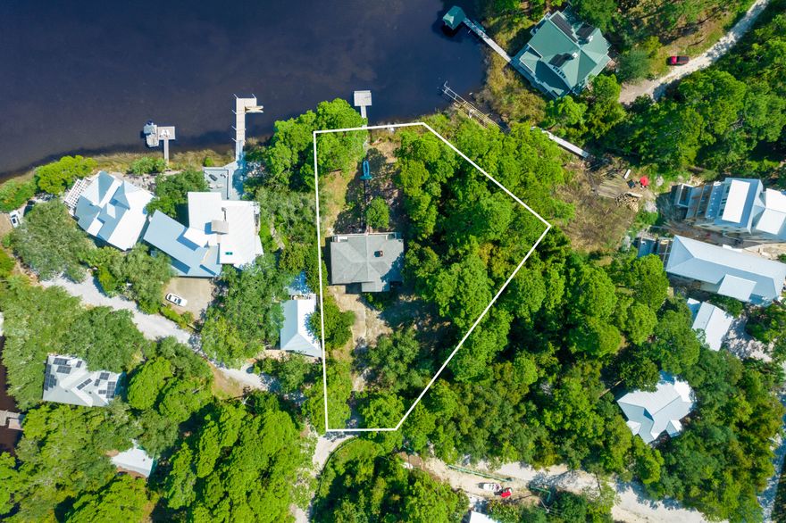 2 lots on the west side of Eastern Lake with a home and dock on lot 4 . Lot 5 is empty.  45 feet of lakefront and gulf views are possible