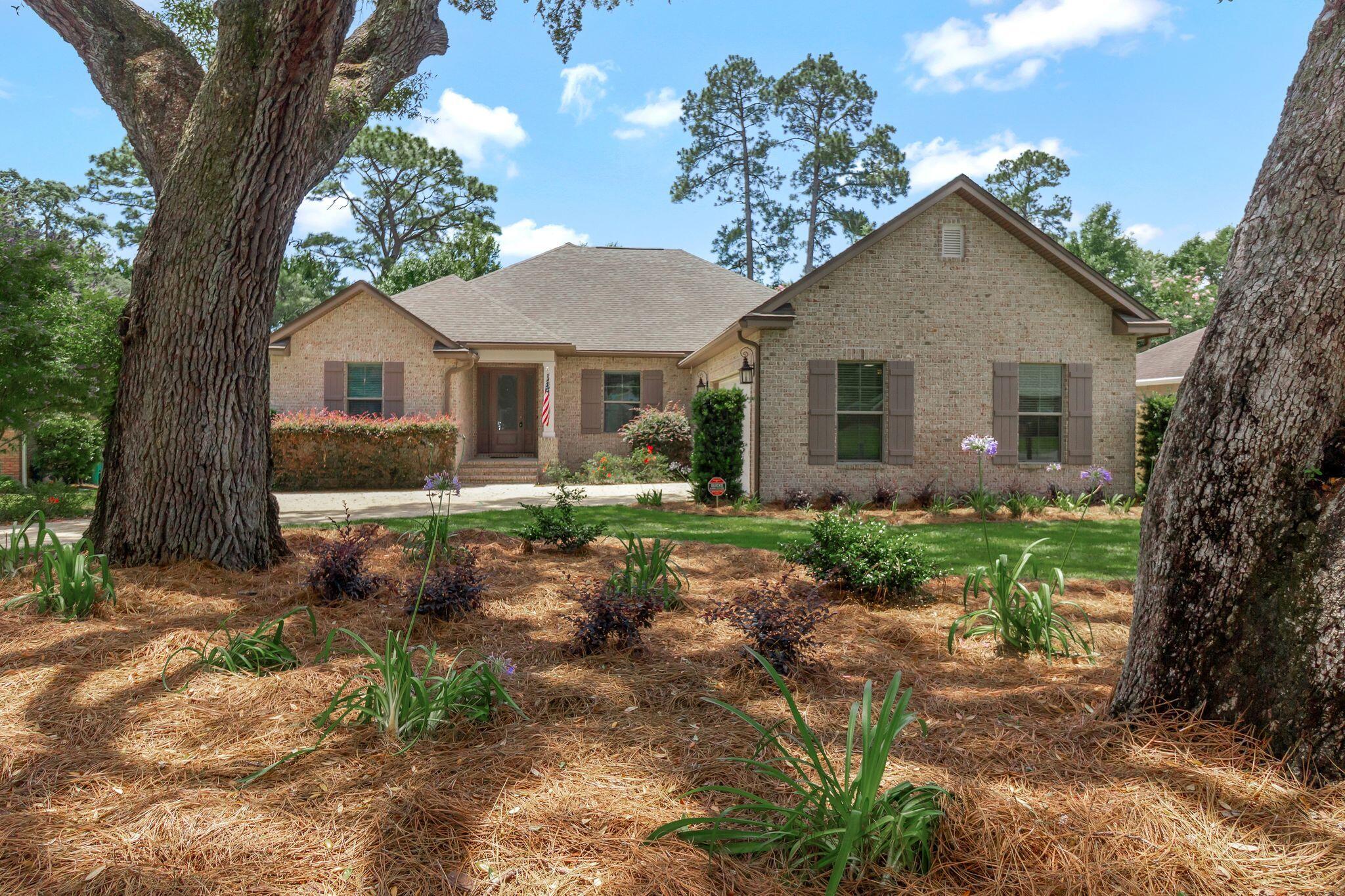 Welcome to your dream home in the heart of Niceville! Nestled on a large cul-de-sac lot beneath a canopy of ancient oak trees, this thoughtfully designed custom home by Key Lime Construction, LLC offers luxury, functionality, and timeless style in every detail.Boasting a triple-split floorplan, this home provides both privacy and versatility. A bedroom and full bath are tucked just off the front foyer--perfect for guests or a private office--while two additional bedrooms and a full bath are located at the rear of the home, discreetly separated from the main living space by a pocket door. The spacious primary suite is set apart on the opposite side of the house and features a serene retreat complete with a large walk-in closet, dual vanities, an oversized custom- tiled shower, and a separate water closet.
The open-concept living area is warm and inviting with wood-look tile, recessed dimmable lighting, and a smart layout perfect for entertaining or everyday comfort. At the heart of the home, the kitchen stuns with a large central island, Kenmore Elite appliances including a gas range, a walk-in pantry with custom wood shelving, under-cabinet lighting, and elegant Avanti Shaker Legacy cabinetry with 42" uppers. For dining options, relax in the charming breakfast nook, dine at the kitchen island or create a formal dining experience in the flexible bonus space separated by frosted glass pocket doors. This space would also make an incredible media room, home gym, or private office!
Step outside to enjoy the screened-in porch and expansive open deck, ideal for grilling, entertaining, or relaxing while overlooking the generously sized, privacy-fenced backyard with ample room for a future pool.
The oversized garage includes an additional 200+ sq ft of flexible space for your workout equipment, workshop needs, or outdoor adventure gear. Every detail in this home has been meticulously curated, including:
5 1/4" baseboards and 5" crown molding
Sound-control insulation in interior walls
Upgraded media wiring throughout
Four exterior hose bibs
Gas plumbing to the back porch for your grill
Soffit outlets for effortless holiday lighting
Gutters with leaf guards
All this, ideally located in the peaceful Huntington Estates, where you're tucked away in a quiet neighborhood yet just minutes from schools, shopping, dining, Eglin AFB, and the Emerald Coast's white sandy beaches.
Don't miss this rare opportunity to own a true custom-built gem in one of Niceville's most desirable neighborhoods. Schedule your private showing today!