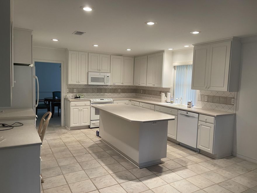 Light and bright contemporary home with 2 story vaulted ceiling in living room, this large room even has a corner gas fireplace. Very large kitchen with eat in area large enough for table and hutch, also has an island with counter height seating, abundant storage in the white cabinets including built in desk and even a pantry.  Dining Room located adjacent to kitchen could easily be a home office.  Master suite has tub and separate enclosed shower along with huge walk in closet. 3 large sliding glass doors from 3 different rooms lead to covered and screened lanai. This home is located in a very private and well maintained community and this residence is located near where the neighborhood dead ends.  Residence was lovingly maintained for over 20 years by the original owners and is being