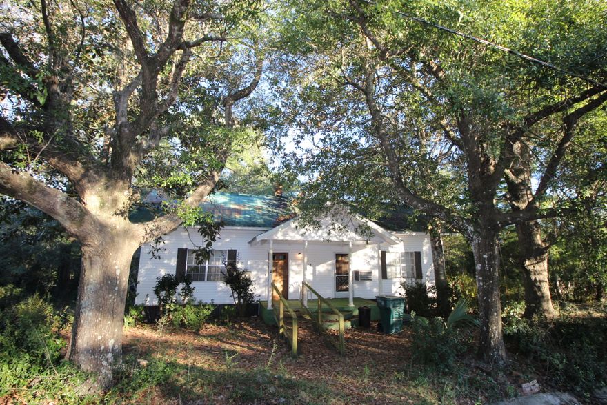 Your chance to own a small piece of DeFuniak history circa 1900. Don't let the 1970's paneling fool you...there are 10' ceilings and tongue and groove walls and ceilings that are just waiting to be uncovered! Not only is there a gem waiting to be polished in the structure itself, but it's located on over 1.6 acres right in the city on South 2nd St. Home does need a good bit of work, but with some elbow grease, could be a beautiful southern cottage again.
