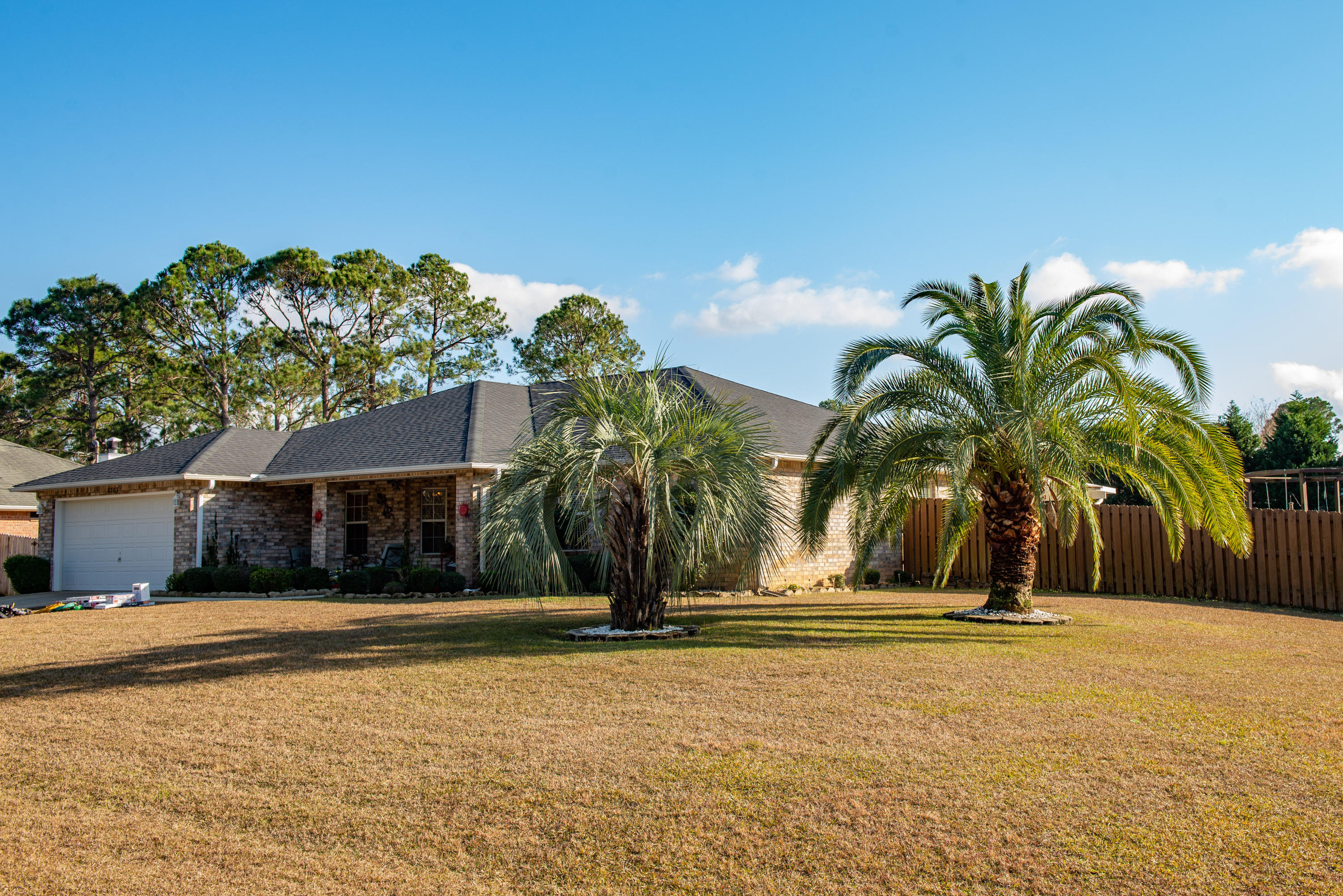 Welcome to YOUR new home! This all-brick home in Holley By The Sea has everything you need and everything you didn't even know you needed! Like to spend your evenings relaxing outdoors? You can hang out at the firepit on one the four pergola swings! Not feeling the weather or the flying critters? That's fine, you've got a fully heated and air conditioned Florida room! Your split floorplan home is completely updated to feature tile and wood laminate flooring throughout (NO CARPETS!), granite countertops, a beautiful walk-in shower and garden tub in the master bath, built-in storage benches in the breakfast nook, built-in wiring for surround sound in the living room, and so much more! The water heater was replaced in 2015, A/C in 2020, and it just got a BRAND NEW ROOF!