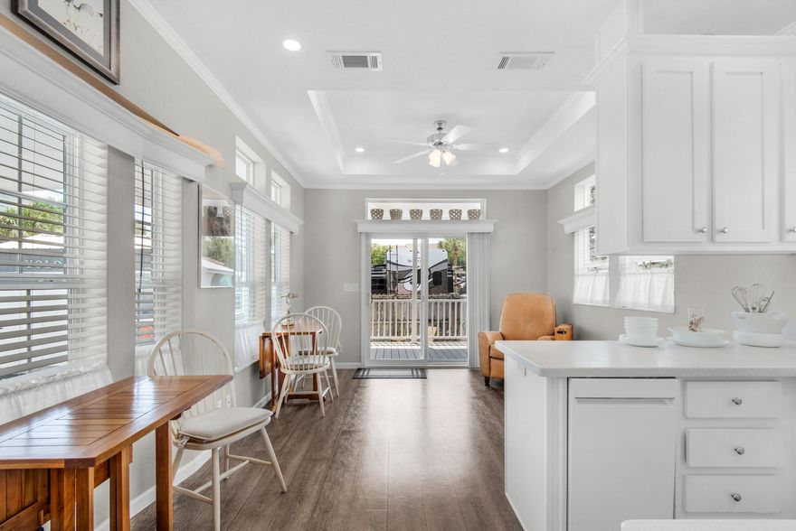 Divine home built in 2020 with large carport, five minute walk to Gulf of Mexico beach!  Gorgeous, clean design in this fresh custom 'RV PARK Model' with bay and transom windows to bring in much natural light.  Metal roof, large covered porch!  You'll love the wood look floors contrasted with high style white backdrop, coffered and 9' ceilings, and creative storage throughout. Heated, cooled and insulated shed would make a delightful reading, lounging or thinking nook outside of the main home. Hot and cold outdoor shower for after-beach rinse-off! Strictly non-rental community for added privacy. Near a plethora of shopping, restaurants. Walk to Gulf of Mexico beach in 5 minutes, or bike in 2 minutes to Pompano Joe's!