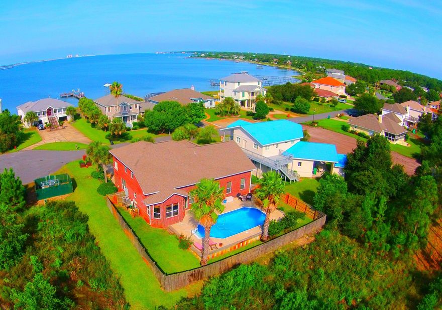 BEACH ACCESS COMMUNITY EXCLUSIVE TO EMERALD POINT! 4 Bedroom, 3 Bath custom built brick home with in-ground pool (brand new liner!). GREAT FOR SECOND HOME! VA FINANCING APPROVED! Convenient to beaches, shopping, fishing, bike rides, 15 miles to Destin. Home Features Master suite and Mother In Law suite on first floor. You will love the open design of your kitchen graciously lined with custom cabinetry & granite counter tops, stainless steel appliances, 2 breakfast bars and a granite kitchen island, beautifully sunlit breakfast room & separate dining room! This open great room offers a cozy gas fireplace, Wood Grain tiled floors, custom entertainment center and built in surround sound Spacious Master Suite with a perfect view of your sparkling pool with his and her walk in closets. Master bath features his and her separate vanity, Jacuzzi tub & separate shower. Second floor includes 2 bedrooms with great closet space, bathroom with double vanity, an office & a beautiful balcony that will make you never want to leave home!  Over sized 2 car garage with an extra large garage door accessible for boat or over sized truck. More amazing features include heavy orange peel textured walls, knock down textured ceilings, 9ft ceilings in bedrooms & vaulted ceilings in kitchen and great room, plantations shutters, recessed and can lighting & modern fixtures, ceramic tile & wood grain tile throughout with new carpet in bedrooms, over sized walk ways and doors, various handicap accessible features. Bonus: Anchor your Boat in sound across the street! NO FLOOD INSURANCE REQUIRED! CALL TO SEE TODAY!! 
