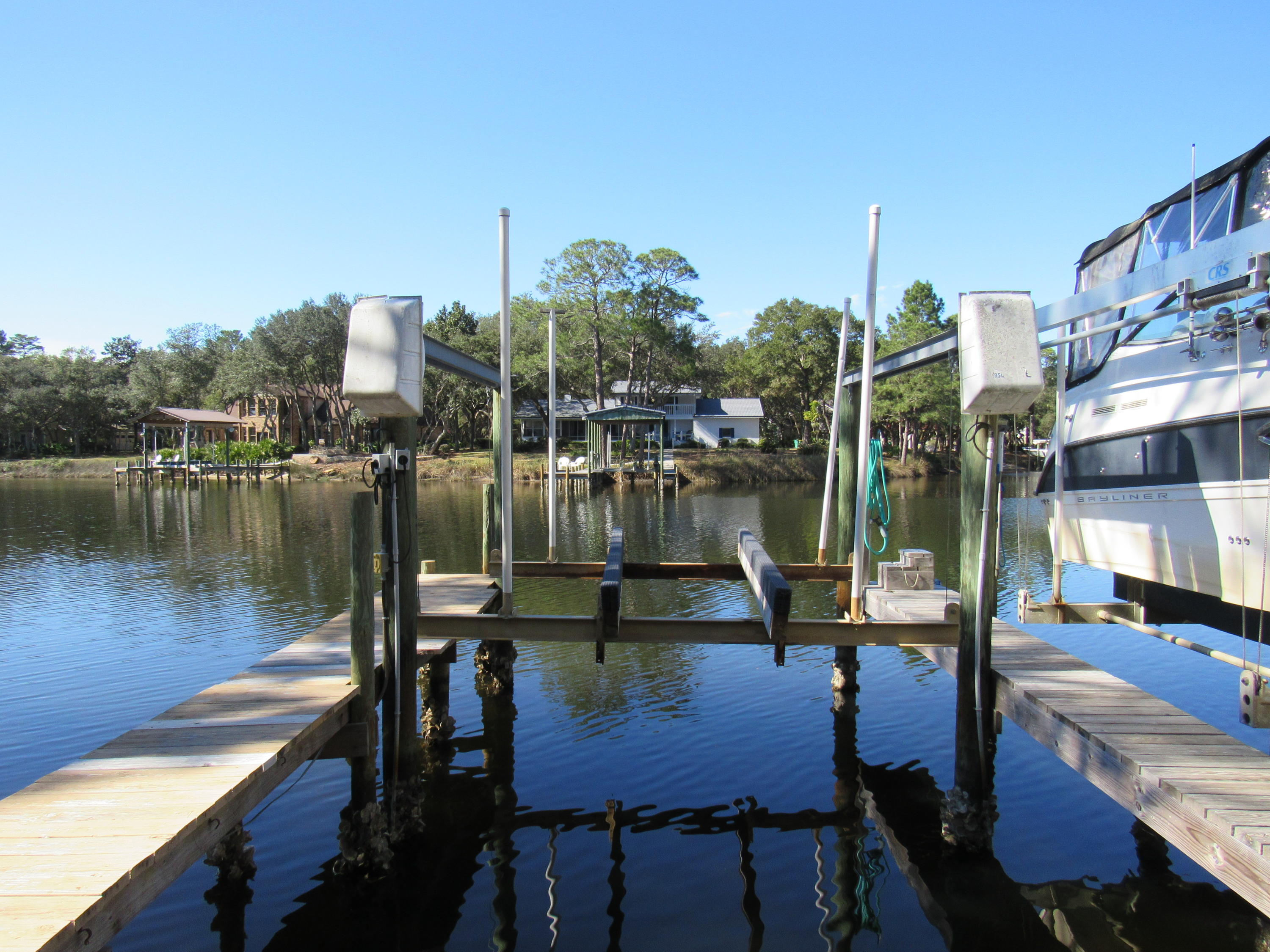 Home is currently under contract with a Kick-out clause. Waterfront in Niceville w/ Boat dock & lift, DEEP WATER!! 4 Bed/2 Full Bath (2 Bed/1 Bath downstairs and 2 Bed/1 Bath upstairs), Vaulted ceilings, fireplace, new carpet, freshly painted, lot is double the size of other lots in development. Fully fenced back yard, dock, boat lift, 25' of waterfront, deck for entertaining, HVAC 2016, roof 2017, newer appliances, 2 car garage, plenty of space for family and friends all in a great location!! Flood insurance not required! Buyer to verify all deemed important information. Link to property Video: https://drive.google.com/file/d/18QAGwr8fAHQWSbkcRYjDm95wcOWQVg_q/view?usp=sharing