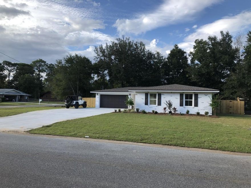 This BEAUTIFUL CORNER LOT WITH A 4 bedroom and 2 bath home is like NEW.... COMPLETELY REMODELED AND GUTTED DOWN to slab inside. All NEW framing, floor plan, wiring, NEW roof, NEW insulation, NEW flooring, most of the plumbing, all sheetrock, custom tile shower in the master bath with a rain head and separate sprayer, bathtub, custom cabinets with soft close drawers, new granite throughout, upgraded appliances including refrigerator, upgraded lighting fixtures, garage door, new laundry room with custom cabinets, island bar, NEW A/C, Heat, flood lights, driveway with RV OR BOAT PAD. NEW FULLY SODDED yard with a new well, sprinkler system and privacy fence. THIS IS LIKE A BRAND NEW HOME!!!! CALL TODAY FOR A VIEWING. IT WILL NOT LAST LONG!!! NO SELLER DISCLOSURE. HOME WAS COMPLETELY